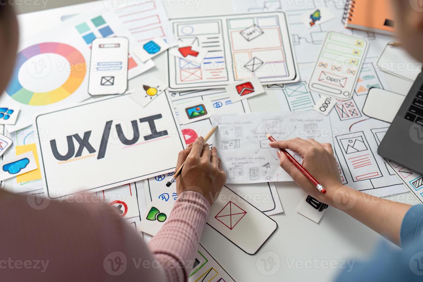 UX and UI Design Focus. Designers sketching user interface wireframes on a table. photo
