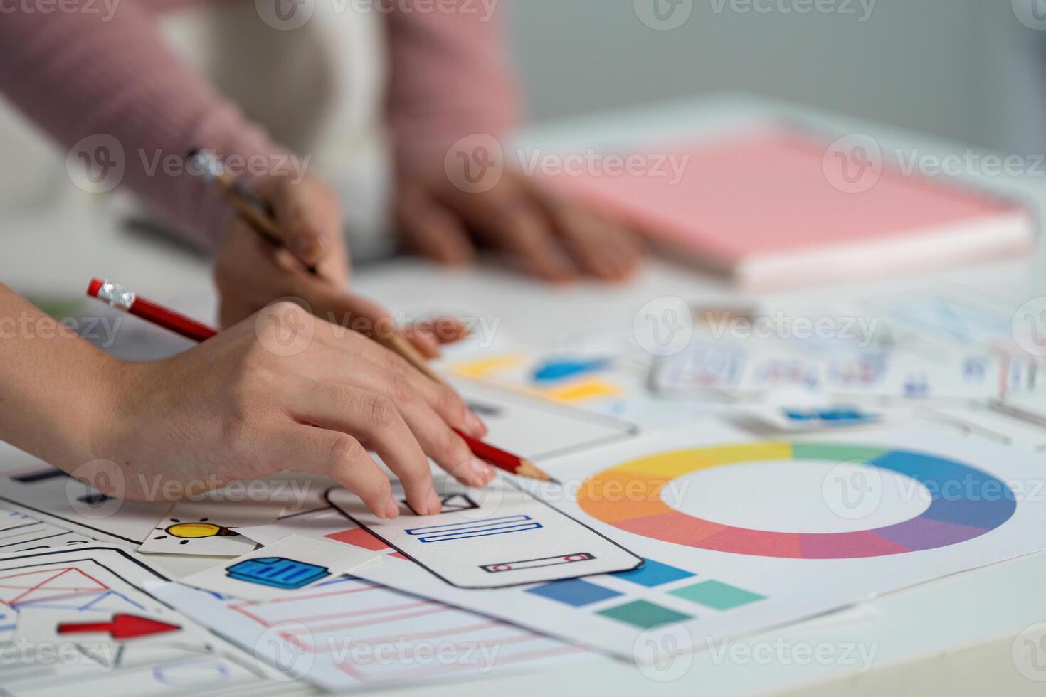 UX and UI Design Process. Designers sketching user interface ideas on paper. photo