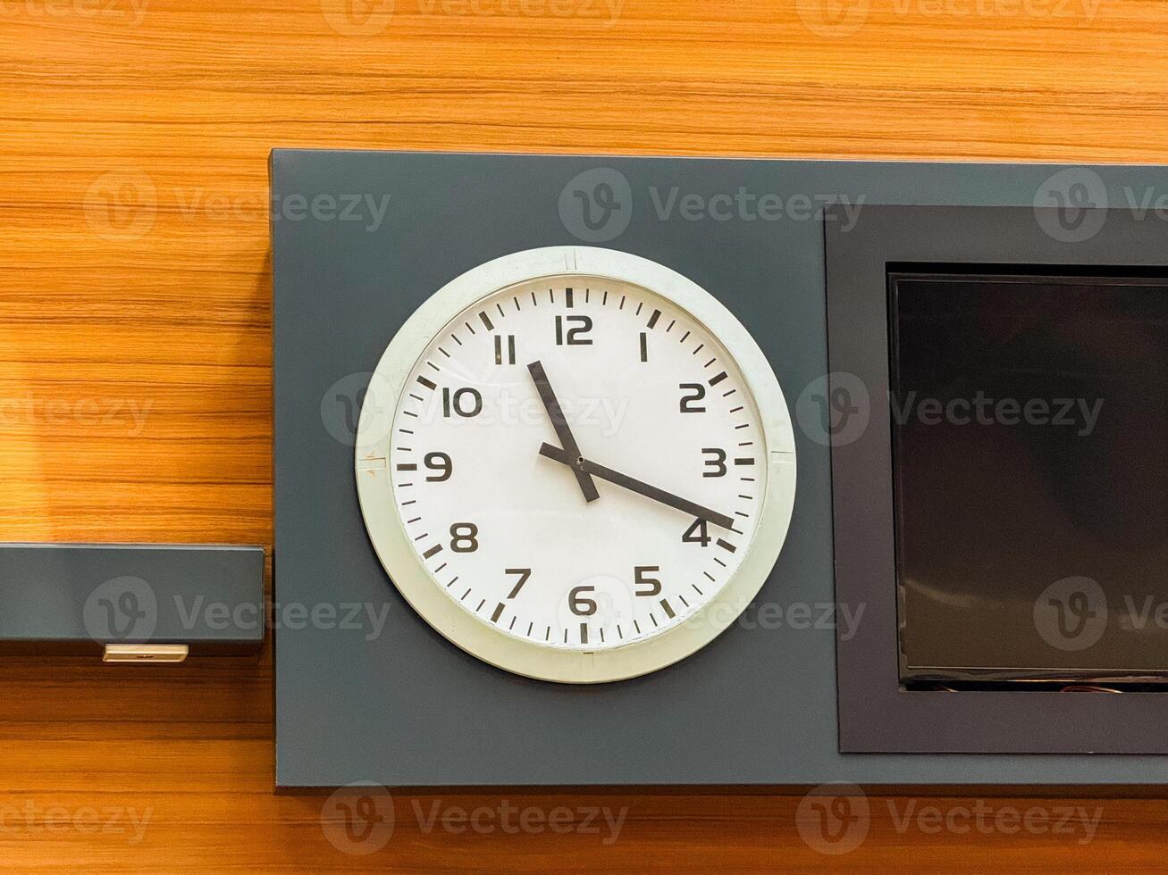 Wall clock showing time in public terminal interior. Time, schedule, and coordination in structured travel and daily environments. photo