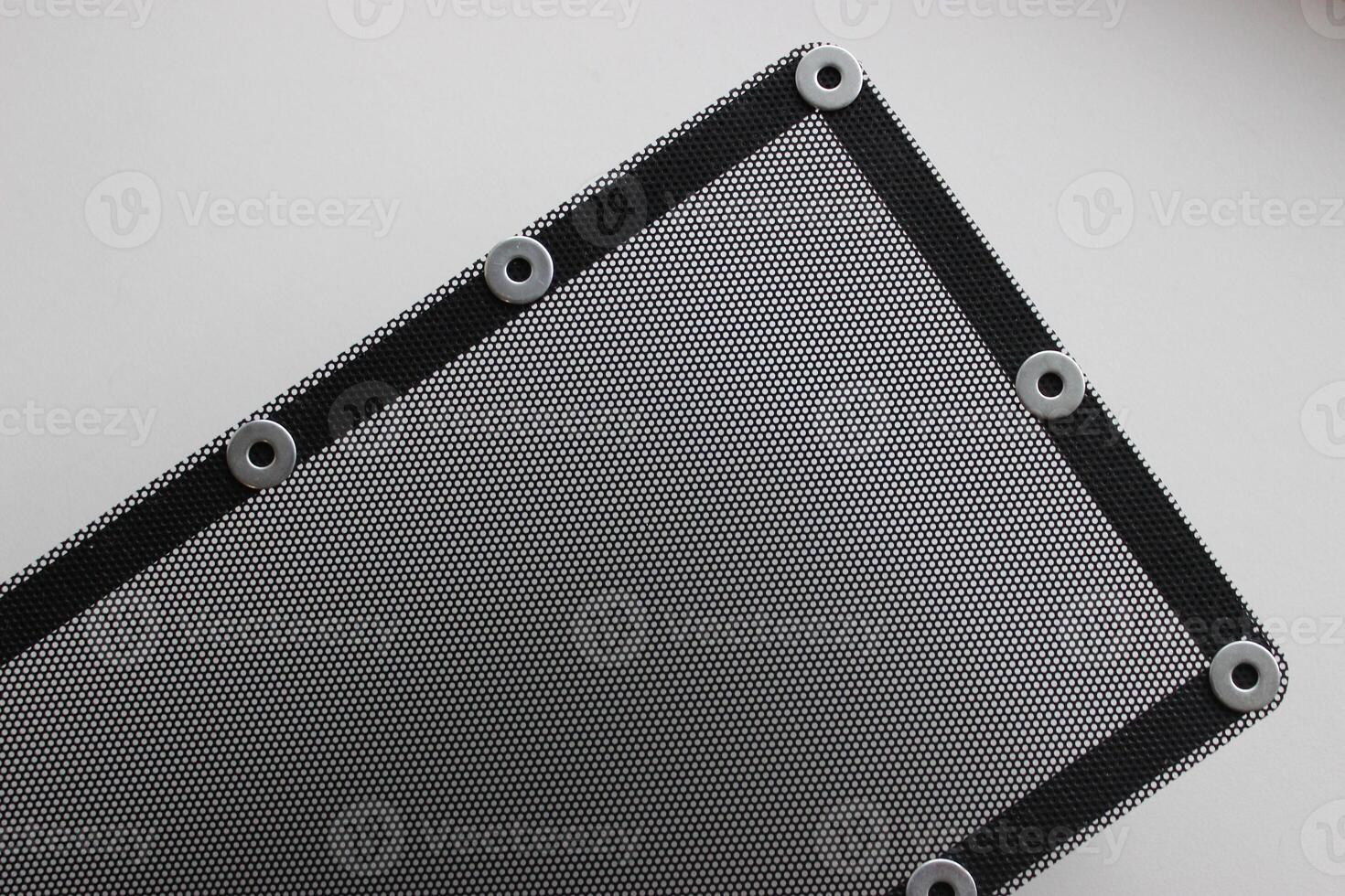 Pattern of protective grill with small round holes and mounting bracket on the frame isolated on white photo