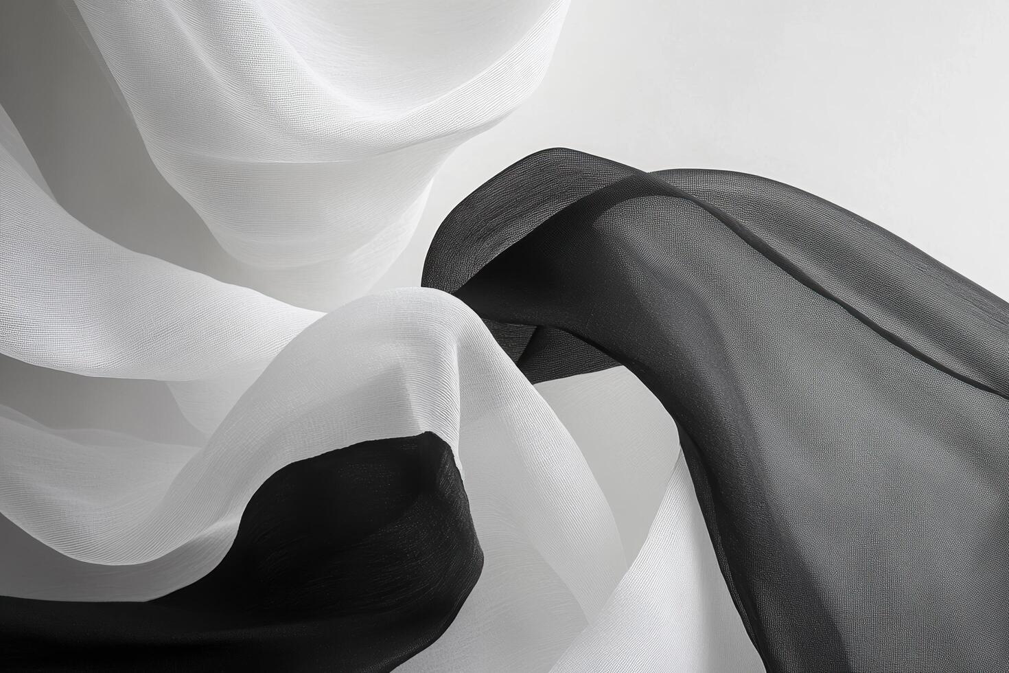 Flowing black and white fabric drapes create elegant textures and patterns photo