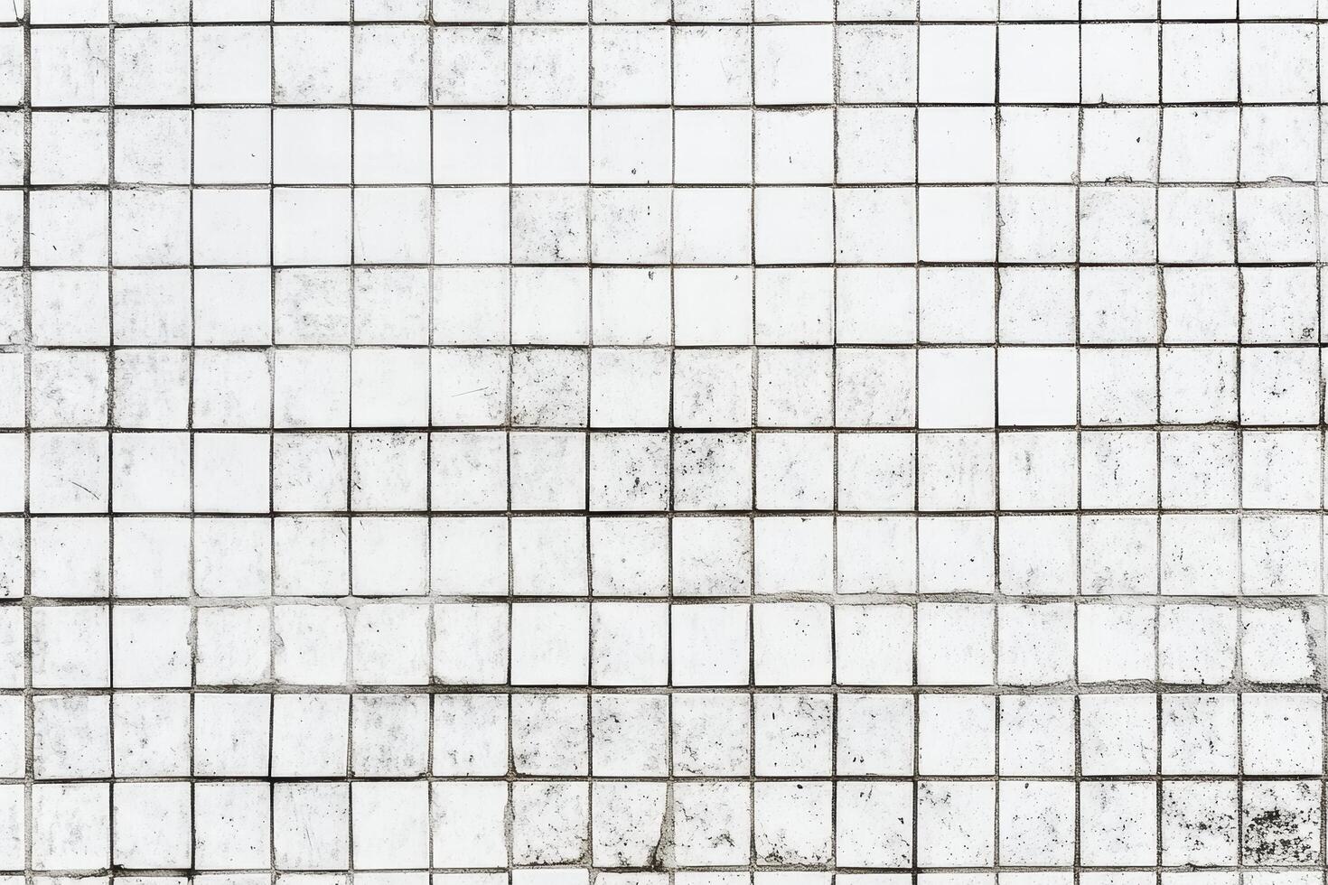 White tiled wall with varying textures and patterns in bright daylight photo