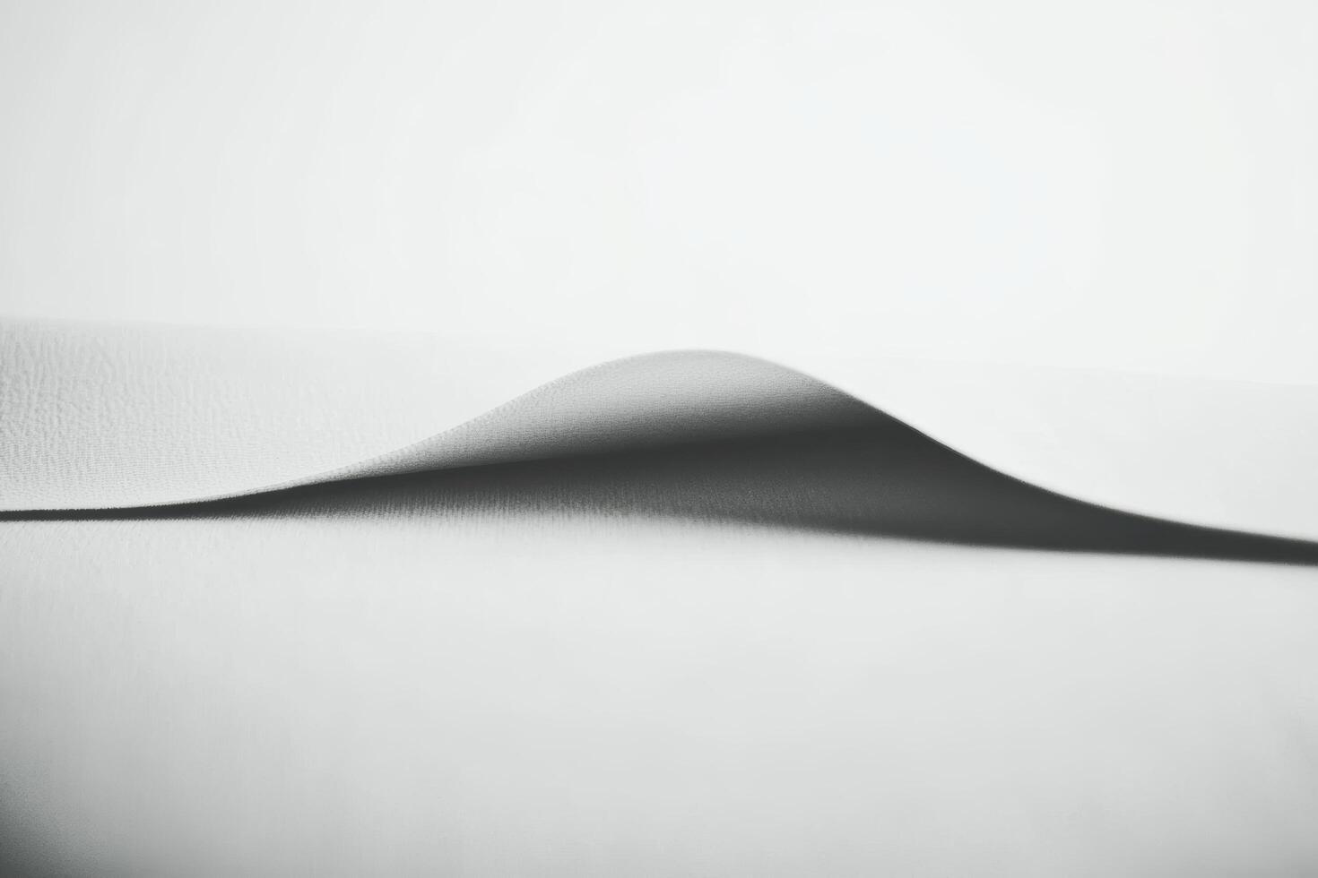 Soft fabric draping elegantly on a flat surface creating gentle curves photo