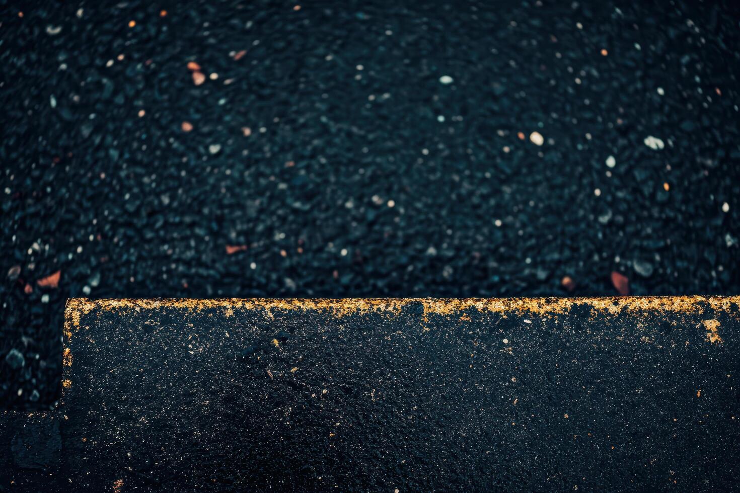 Close-up view of weathered pavement edge with textured surface details photo