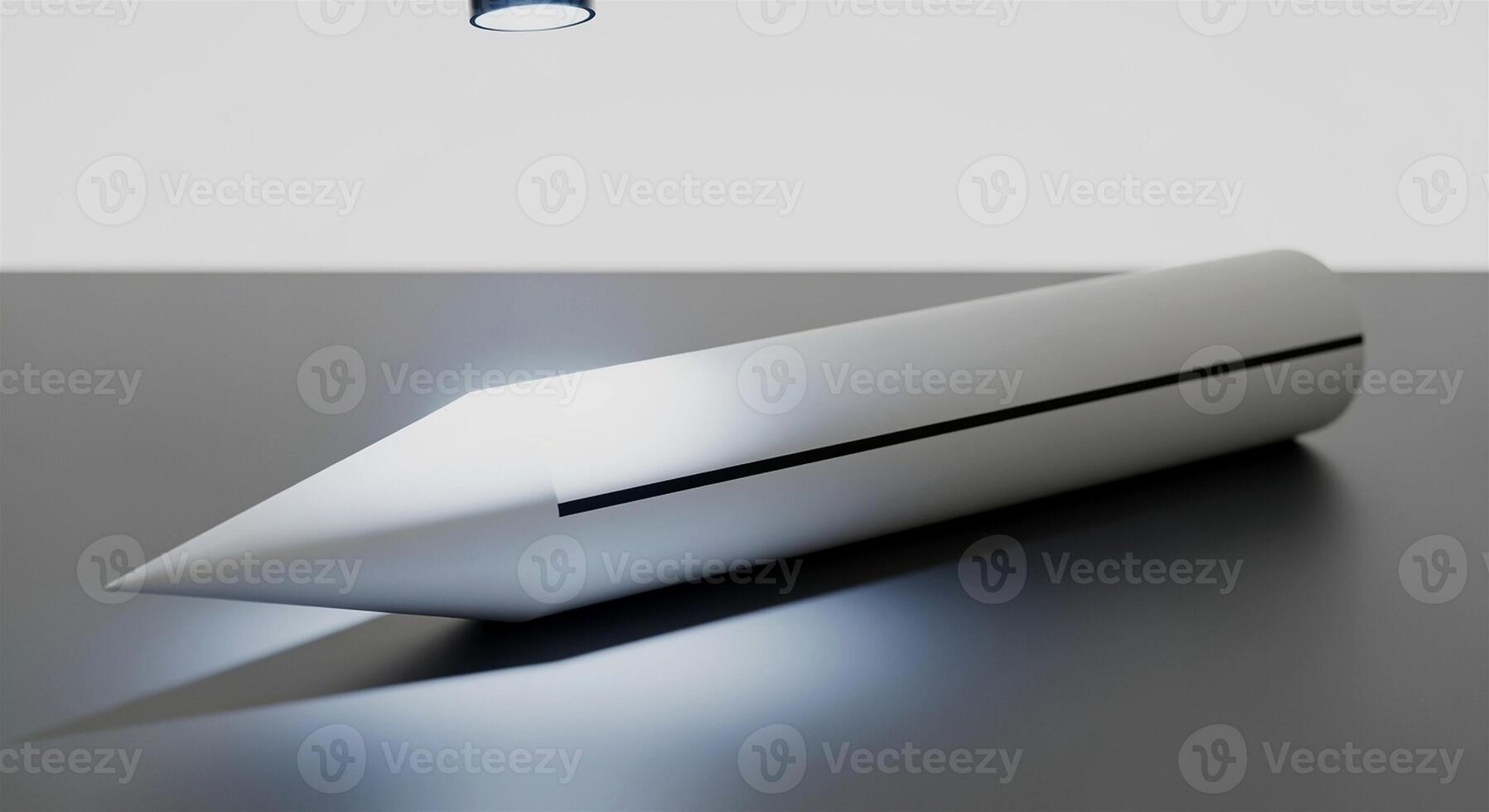 Sleek Silver Object with Sharp Point on Gray Surface. photo