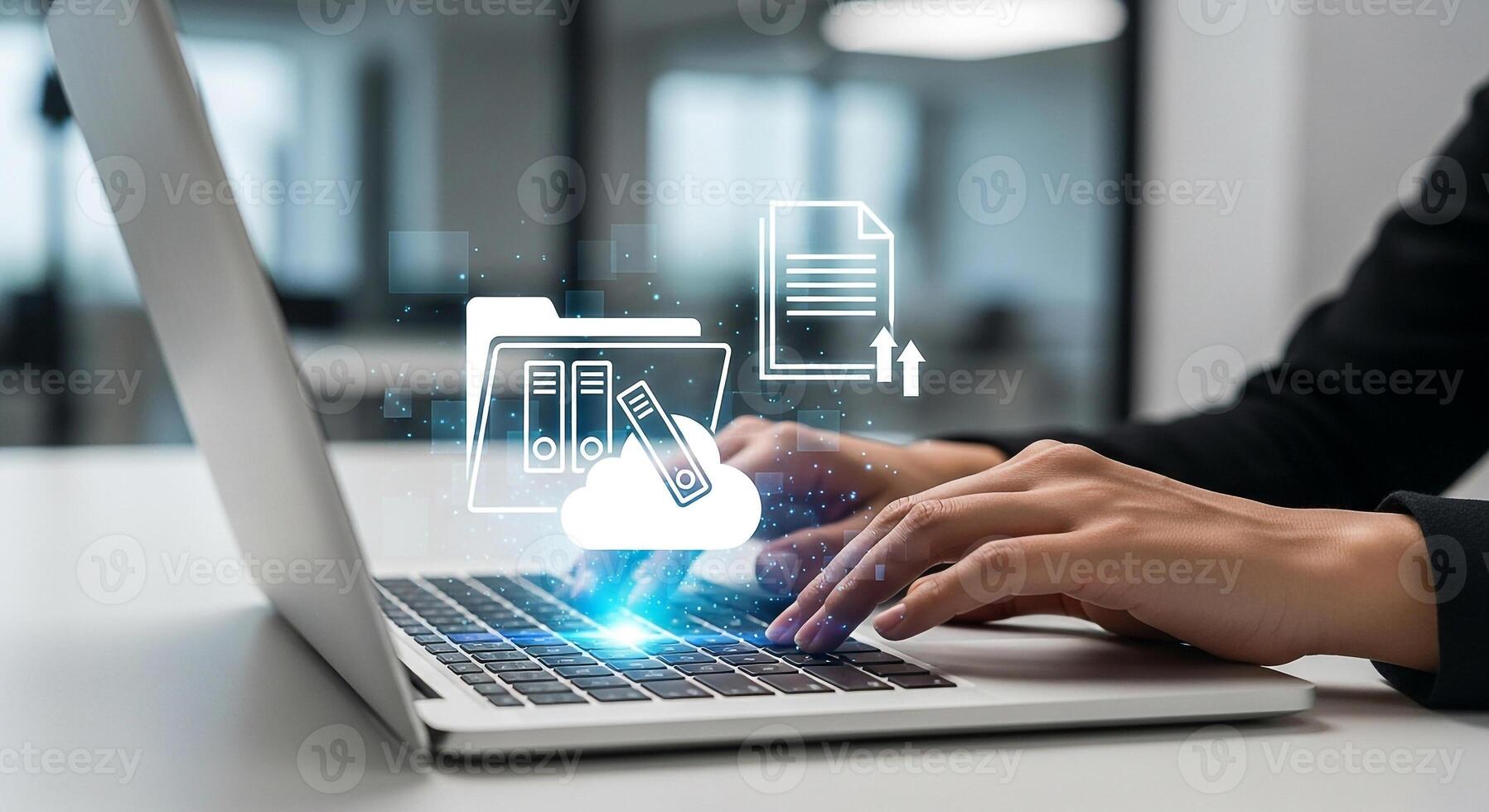 Businesswoman using laptop computer to upload documents to the cloud in a modern office, symbolizing efficient digital workflow and data management photo