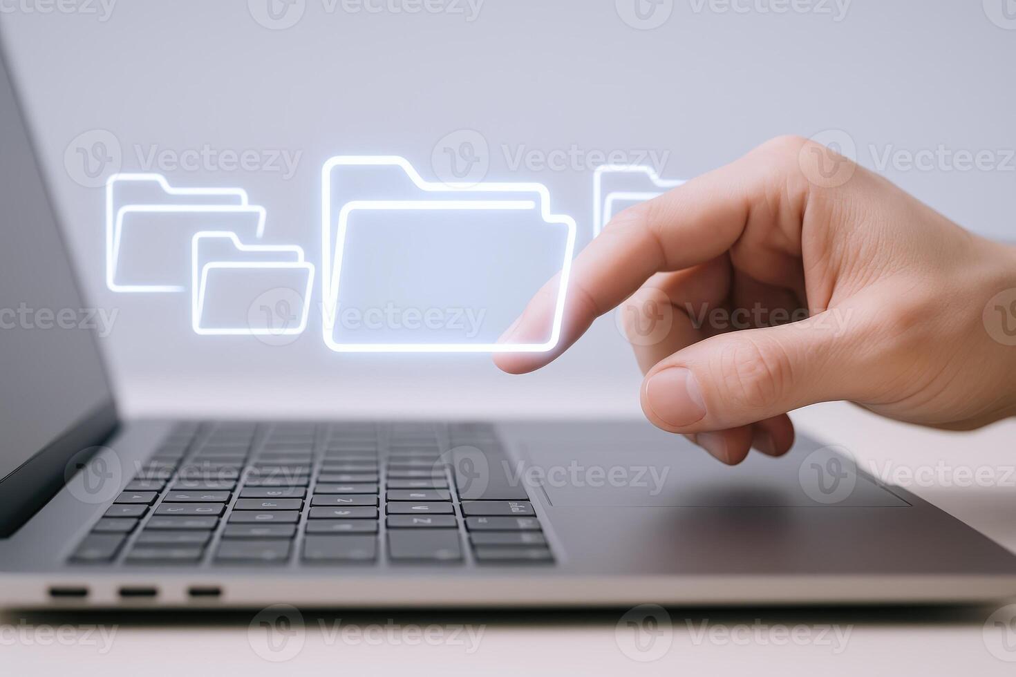 Data Management Hand Interacting with Digital Folders on Laptop, Representing File Organization and Cloud Storage photo