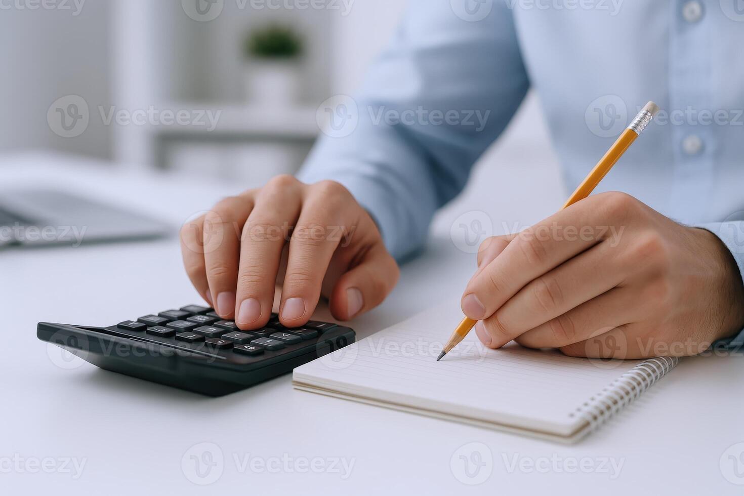 Accountant Calculating Finances and Writing in a Notebook, Close-up View of Hands and Calculator photo