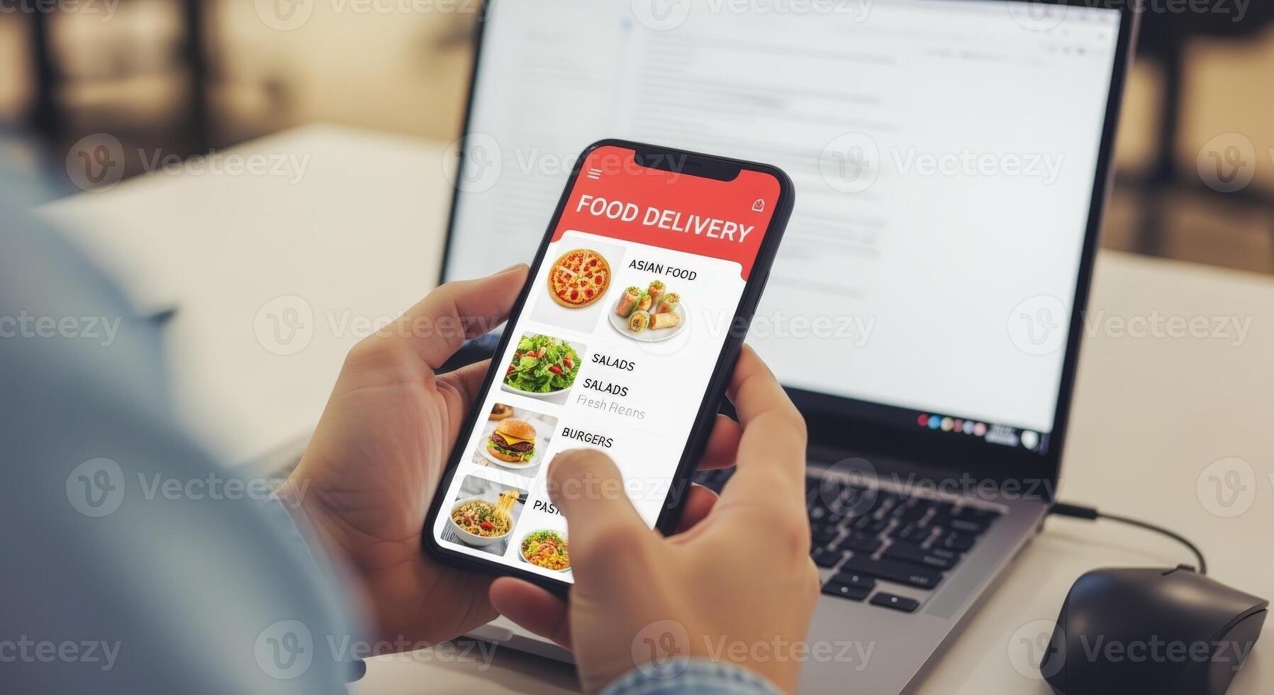Ordering Food Online Using a Mobile App Convenient Contactless Delivery with Laptop in Background photo