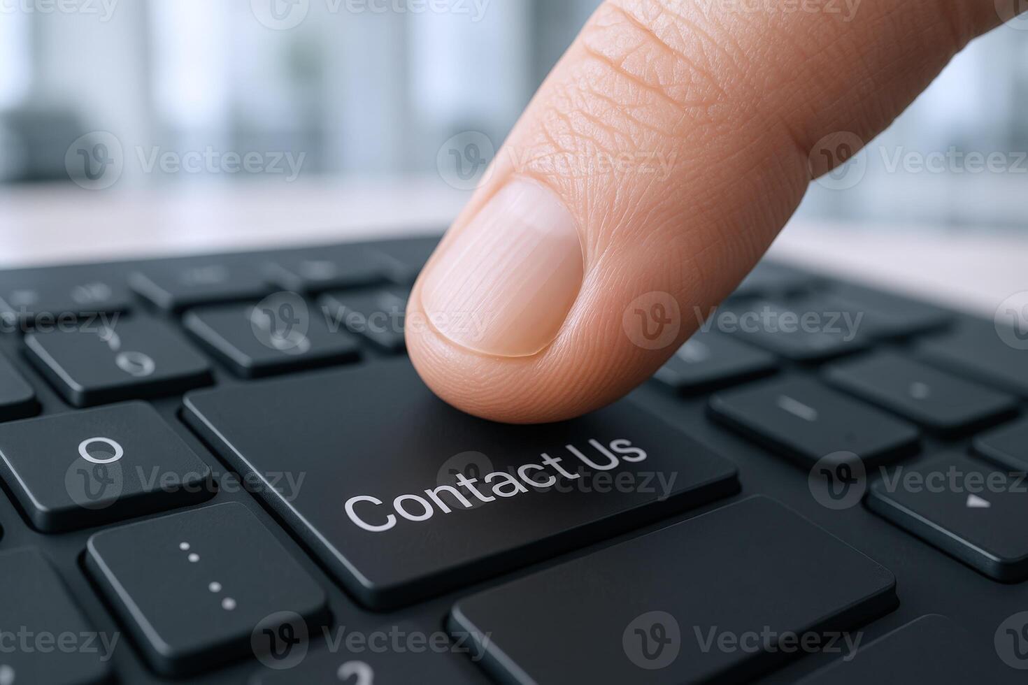 Finger pressing Contact Us button on a computer keyboard, customer service concept for digital communication photo