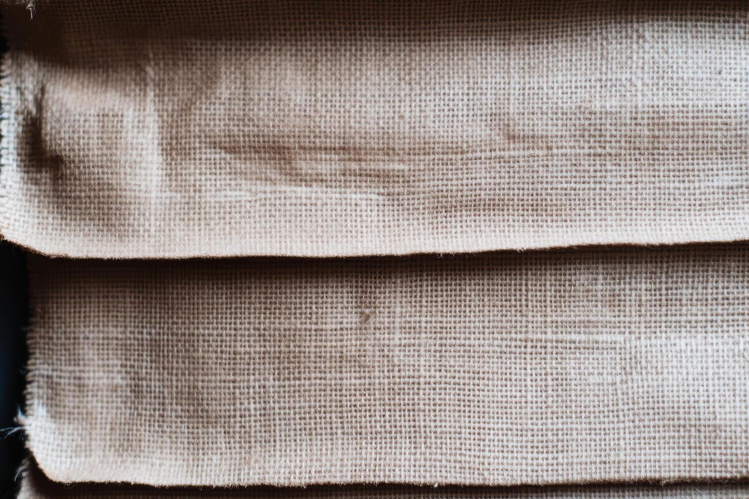 Textured fabric stack displayed on a table in natural light indoors photo