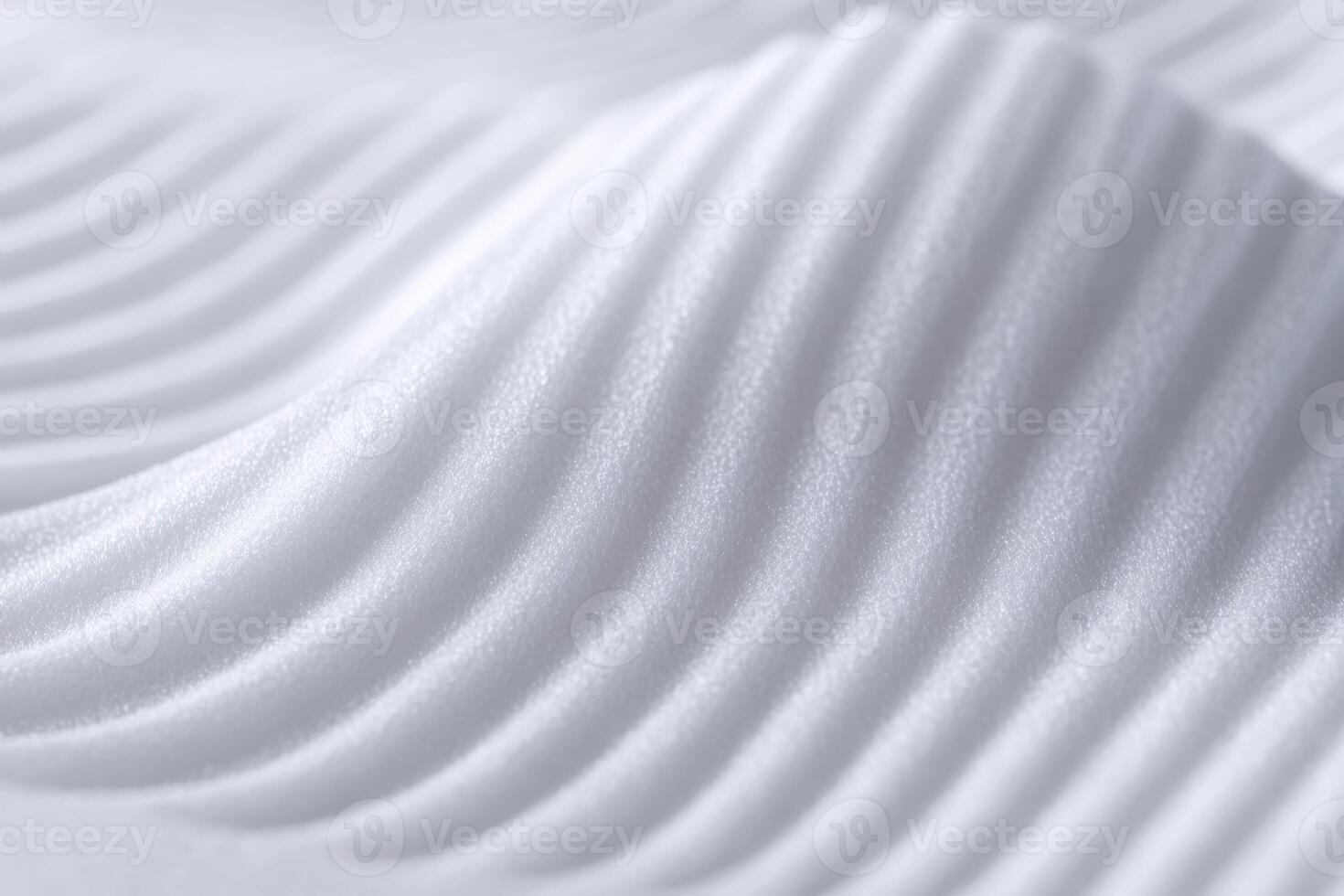 Soft white ripples create an elegant pattern in smooth sand at midday photo