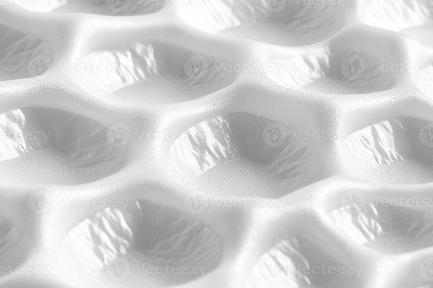 Close-up view of textured surface with hexagonal patterns and shadows photo