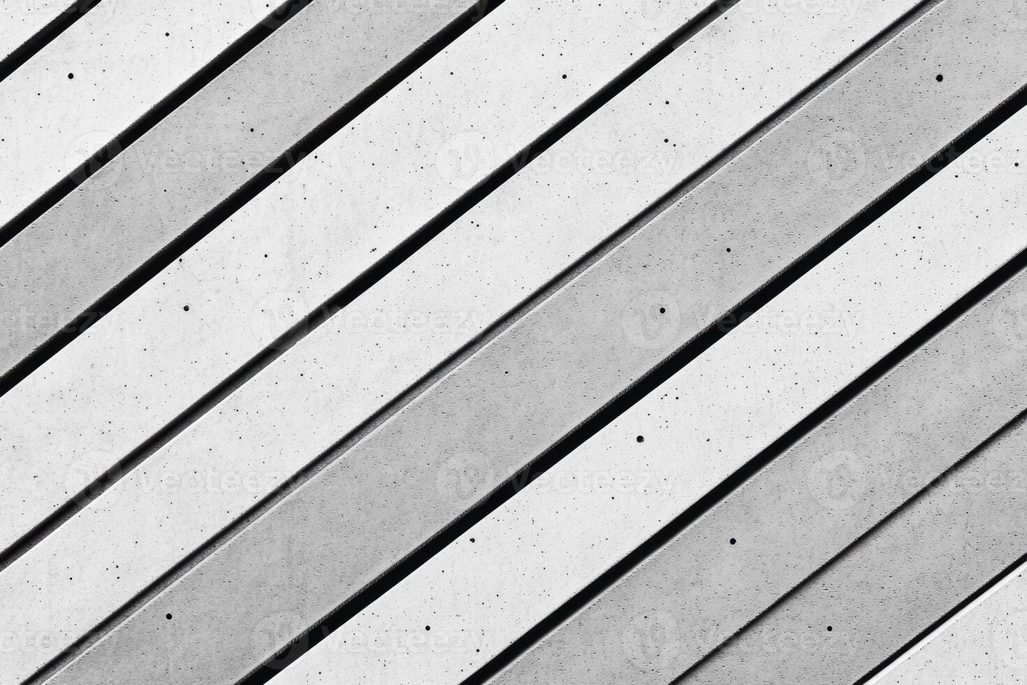 Textured concrete surface with diagonal lines in urban setting during daylight photo
