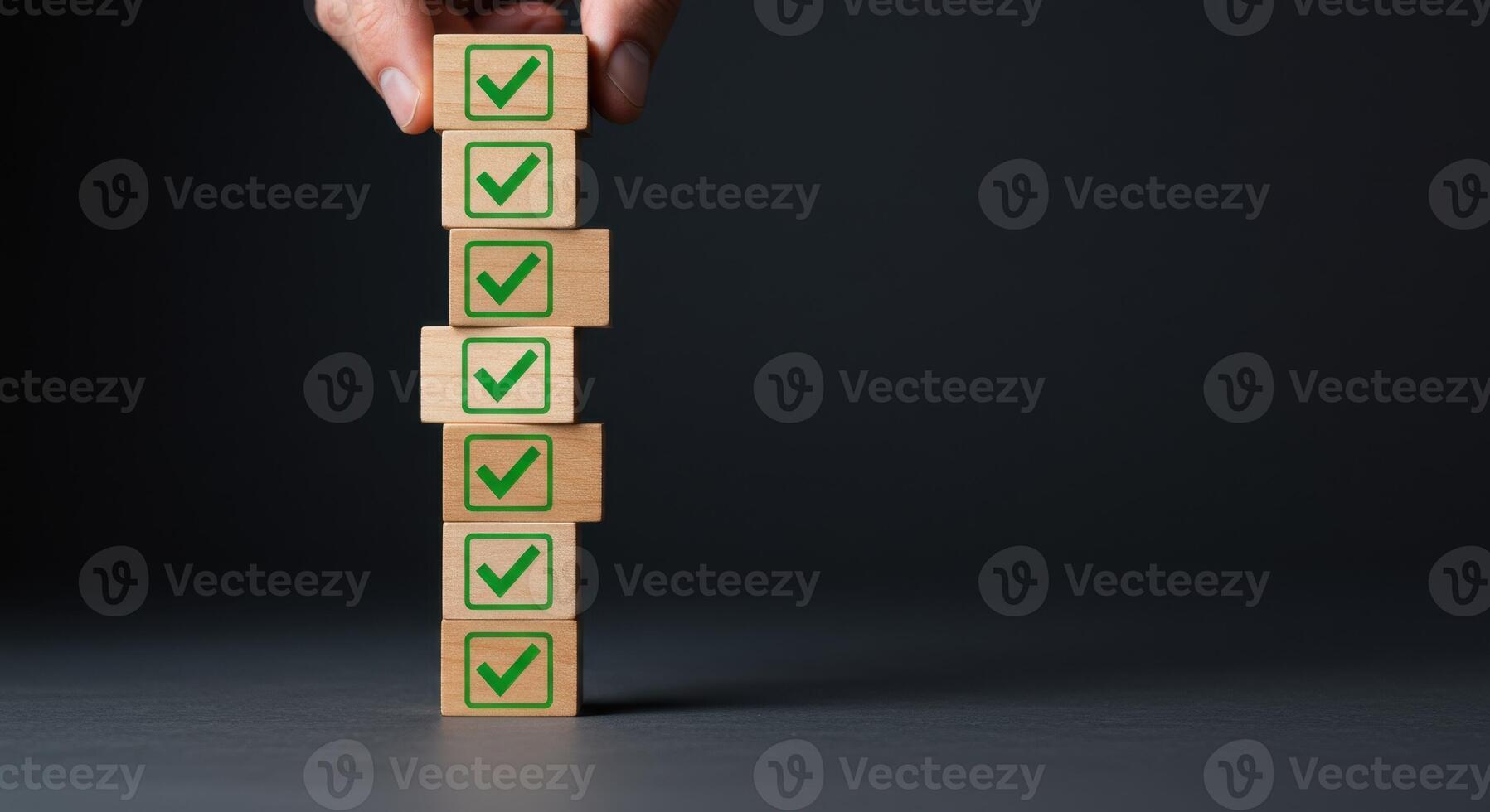 Hand stacking wooden blocks with green check marks, illustrating task completion and success photo
