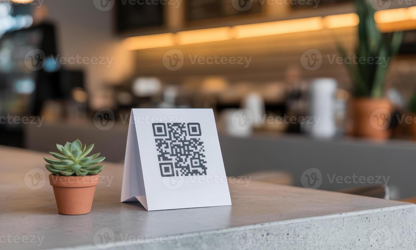 Digital QR code stand on a grey concrete counter in a blurred cafe environment photo