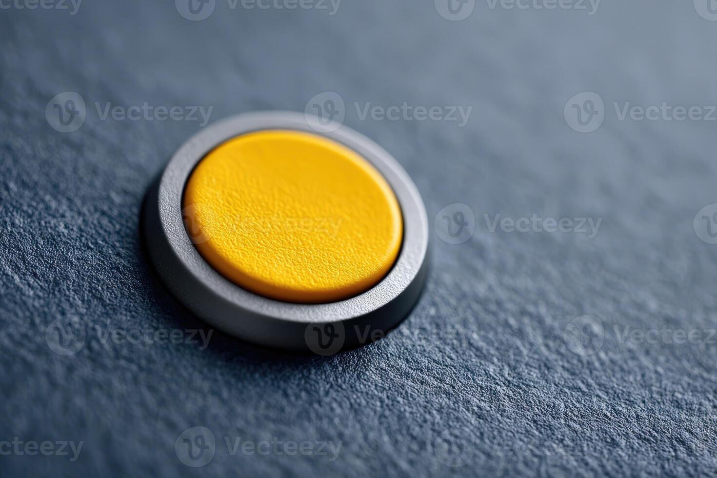 Key embedded in deep blue matte surface with yellow circular button photo