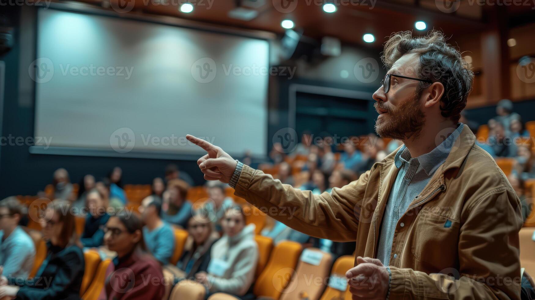 A man is giving a lecture in front of an audience photo