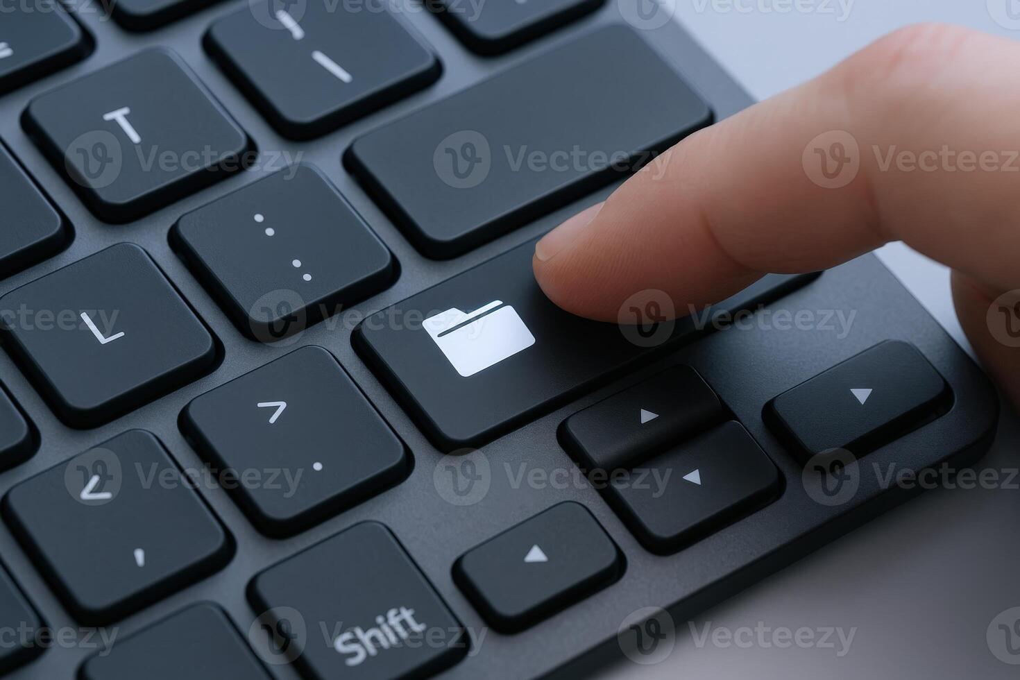 Close-up of a Finger Pressing the Folder Button on a Black Keyboard, Symbolizing Data Management photo