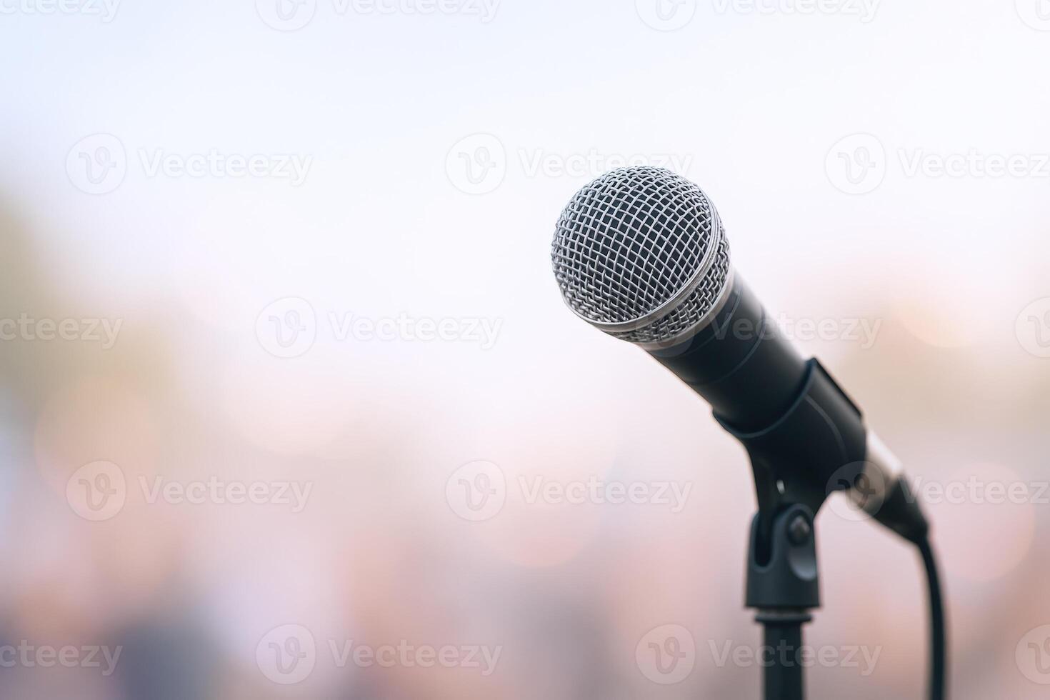 Microphone on Stage Ready for Performance or Speech, Public Speaking Concept with Bokeh Background photo