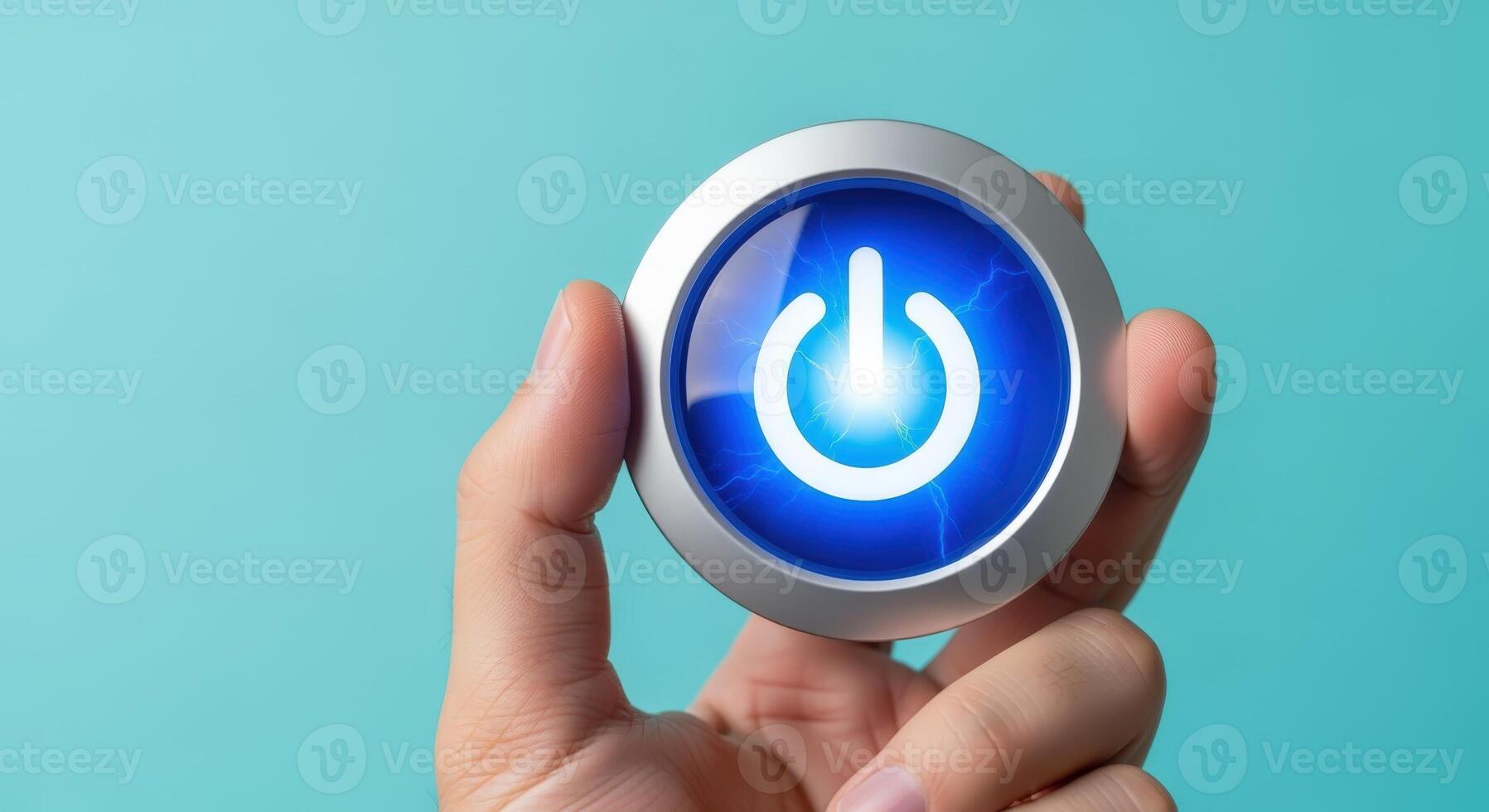 Hand Holding Power Button with Blue Illumination Representing Activation, Control, or System Restart photo