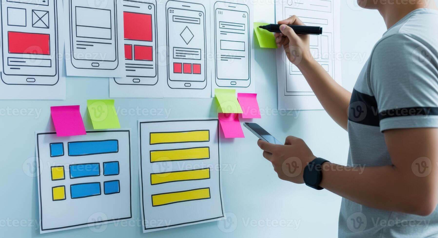 UX designer sketching user interface layouts on a whiteboard with sticky notes for mobile app development photo