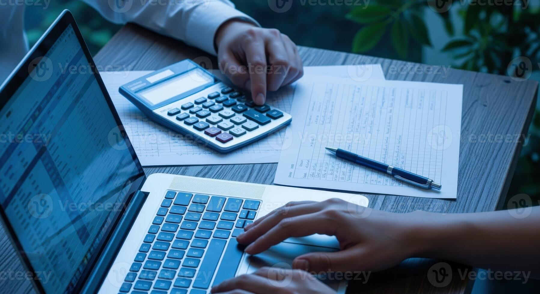 Financial Analyst Calculating Data Using Laptop and Calculator for Business Planning and Budgeting photo
