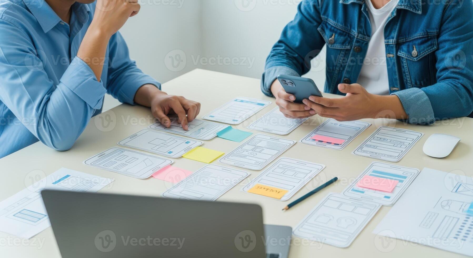 Application design team collaborating on user experience with digital layouts and smartphone interface brainstorming session photo