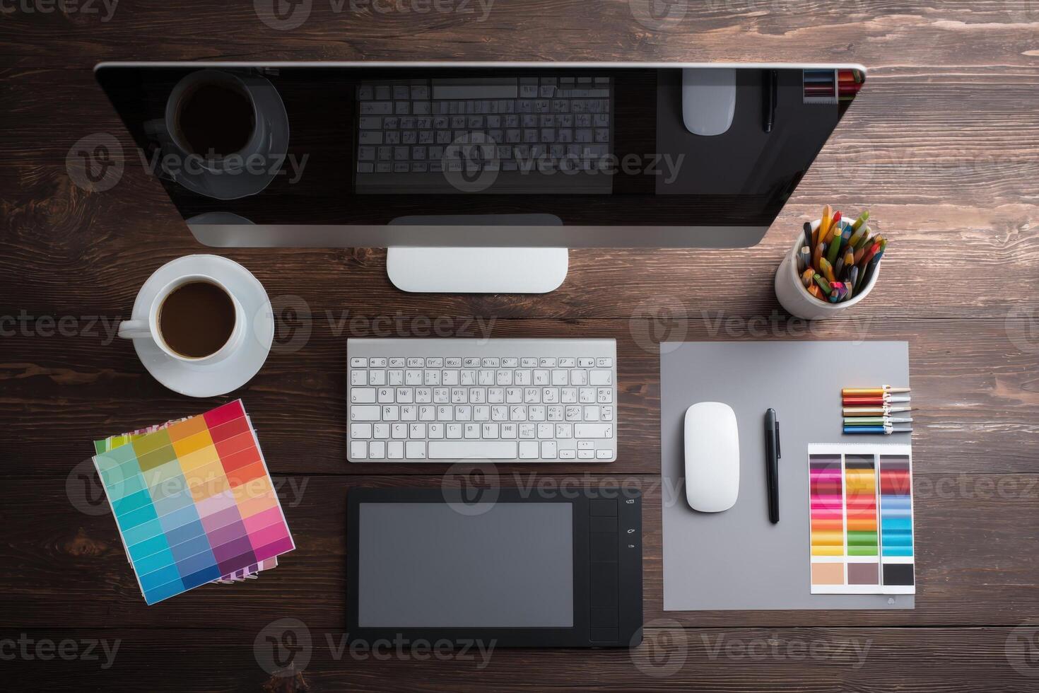 Graphic Designers Workspace with Computer, Tablet, and Color Palette on Wooden Desk for Creative Projects photo