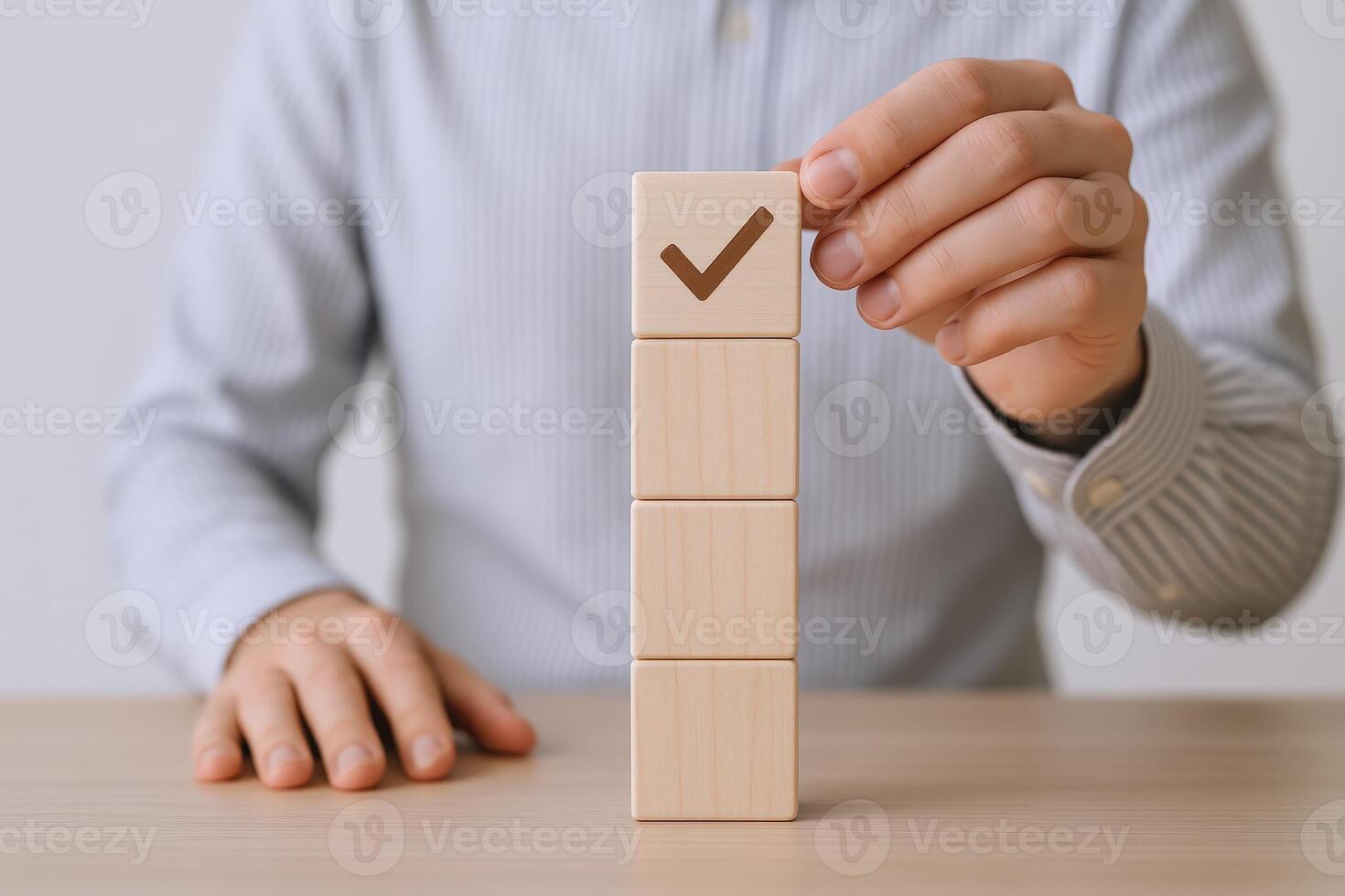 Approval Concept Hand Placing Wooden Block with Check Mark on a Stack of Four Blocks photo