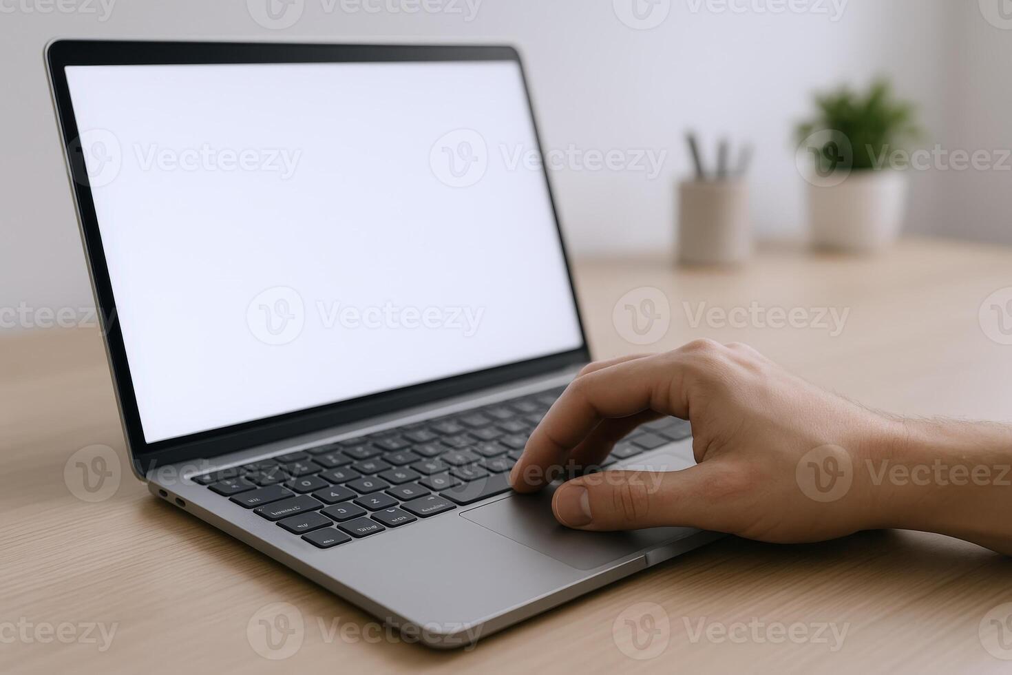 Laptop with Blank Screen on Desk, Hand Using Touchpad for Business or Creative Project photo