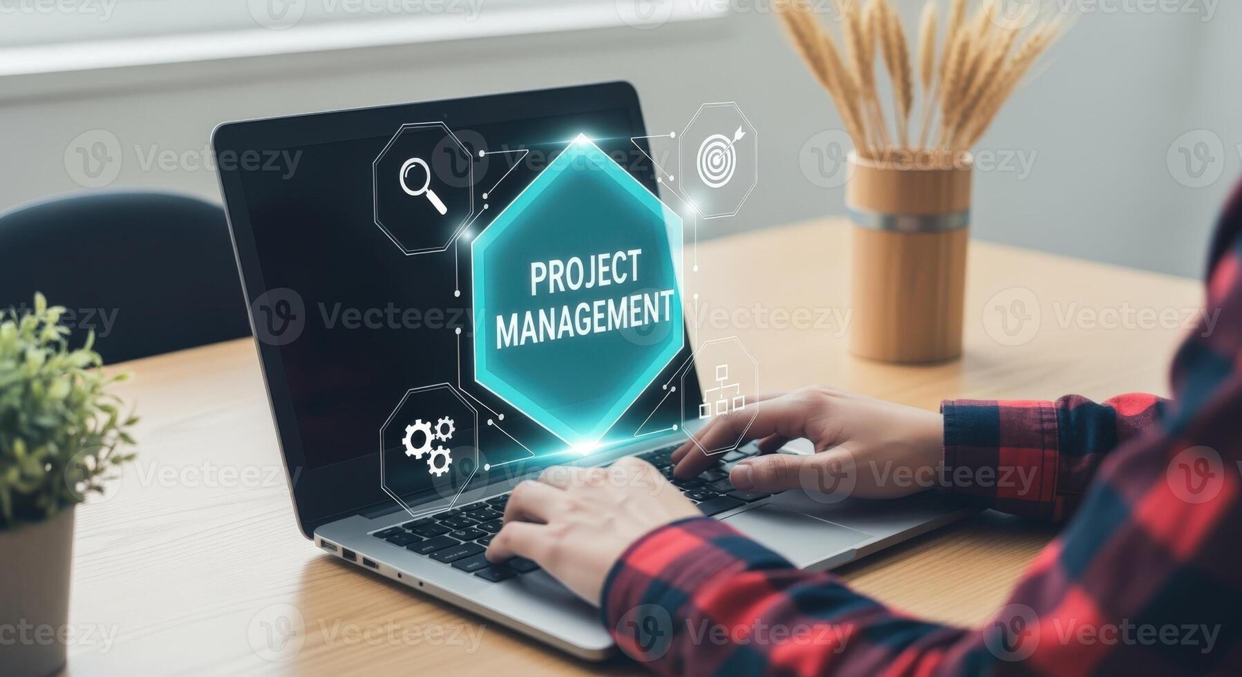 Person using laptop showing project management concept with icons for planning and tracking progress photo