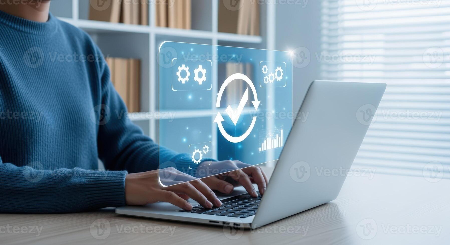 Woman using laptop for process automation, efficiency, and quality control in a modern workspace photo