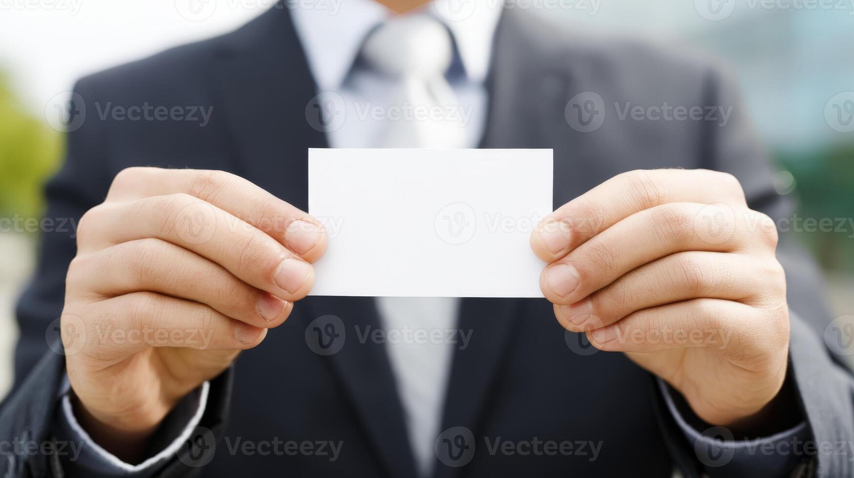 Businessman Displaying a Blank Business Card for Mockup, Promoting Professional Services and Networking photo