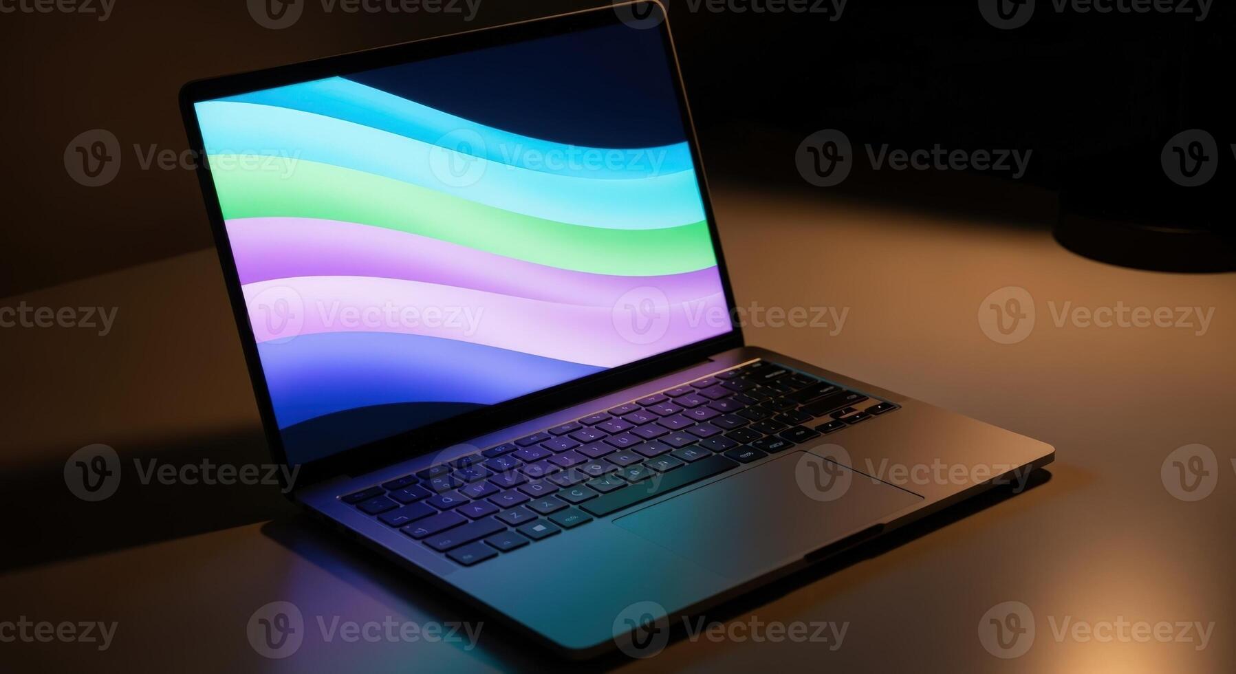 Sleek Open Laptop Displaying Colorful Abstract Wallpaper on Desk, Revealing Keyboard and Touchpad photo