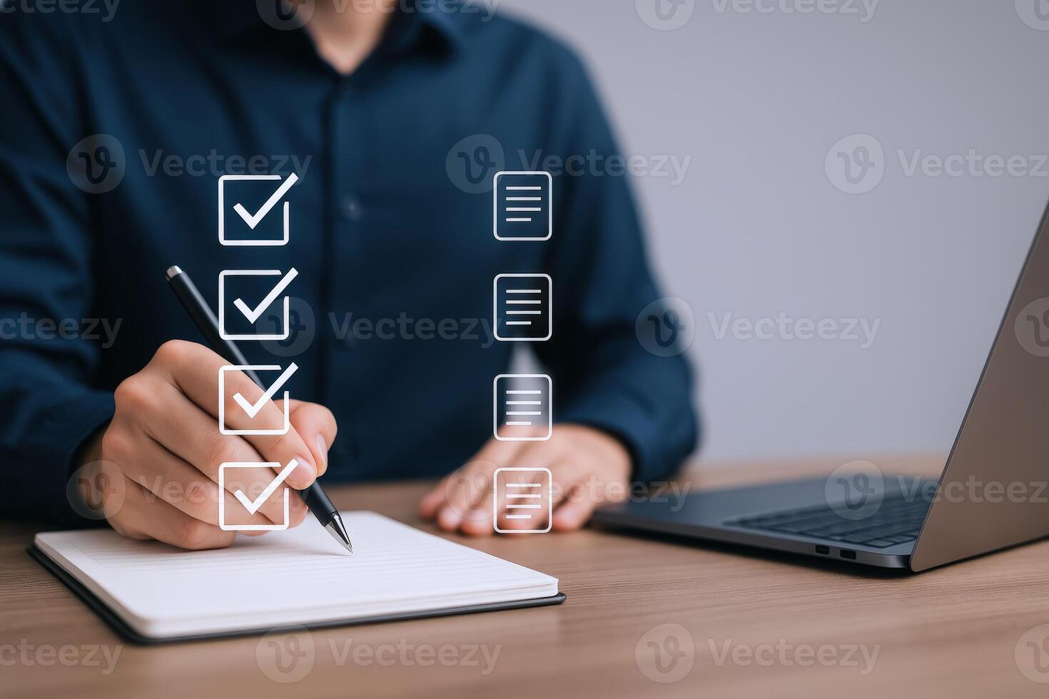 Completing Checklist with Pen Next to Laptop Demonstrating Task Management and Productivity in Modern Workspace photo