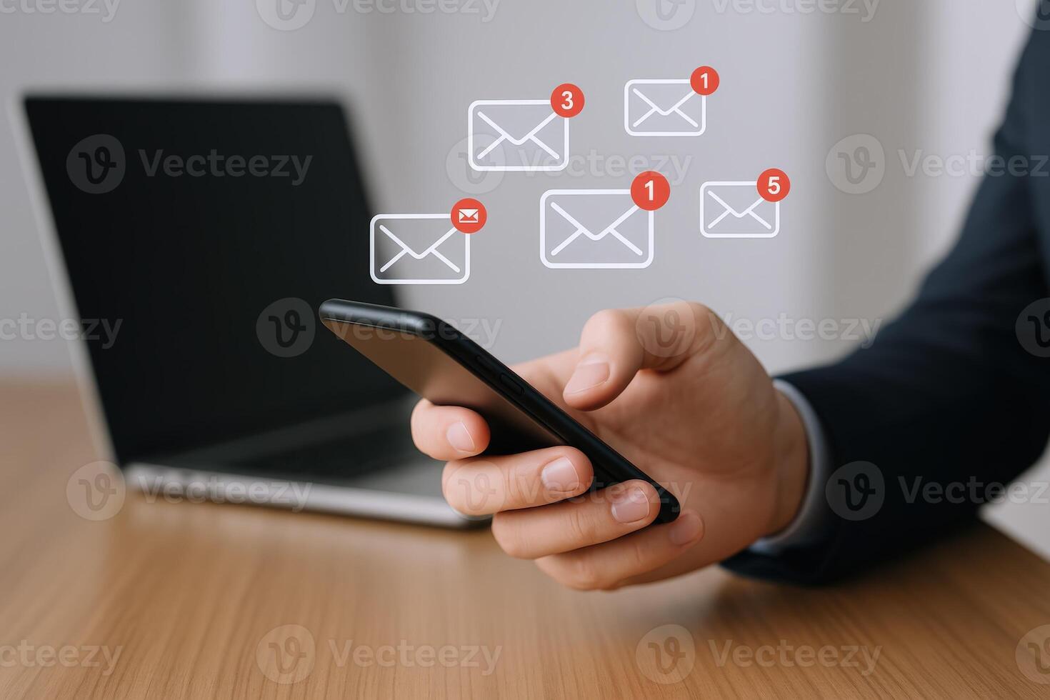 Man Holding Smartphone Checking Email Notifications with Laptop in the Background, Communication and Connectivity photo