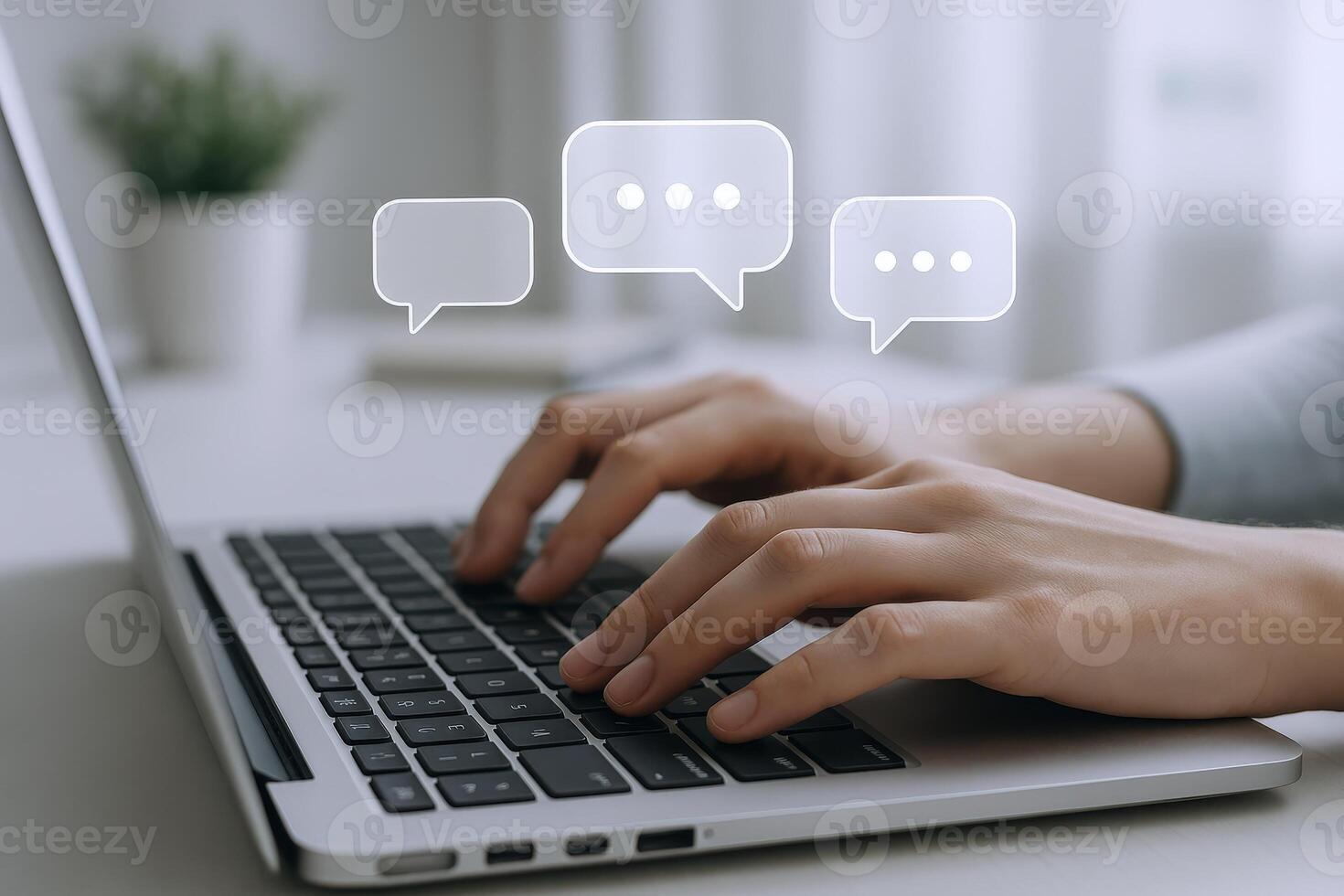 Typing on Laptop with Speech Bubbles Representing Communication and Digital Interaction in Modern Workplace photo