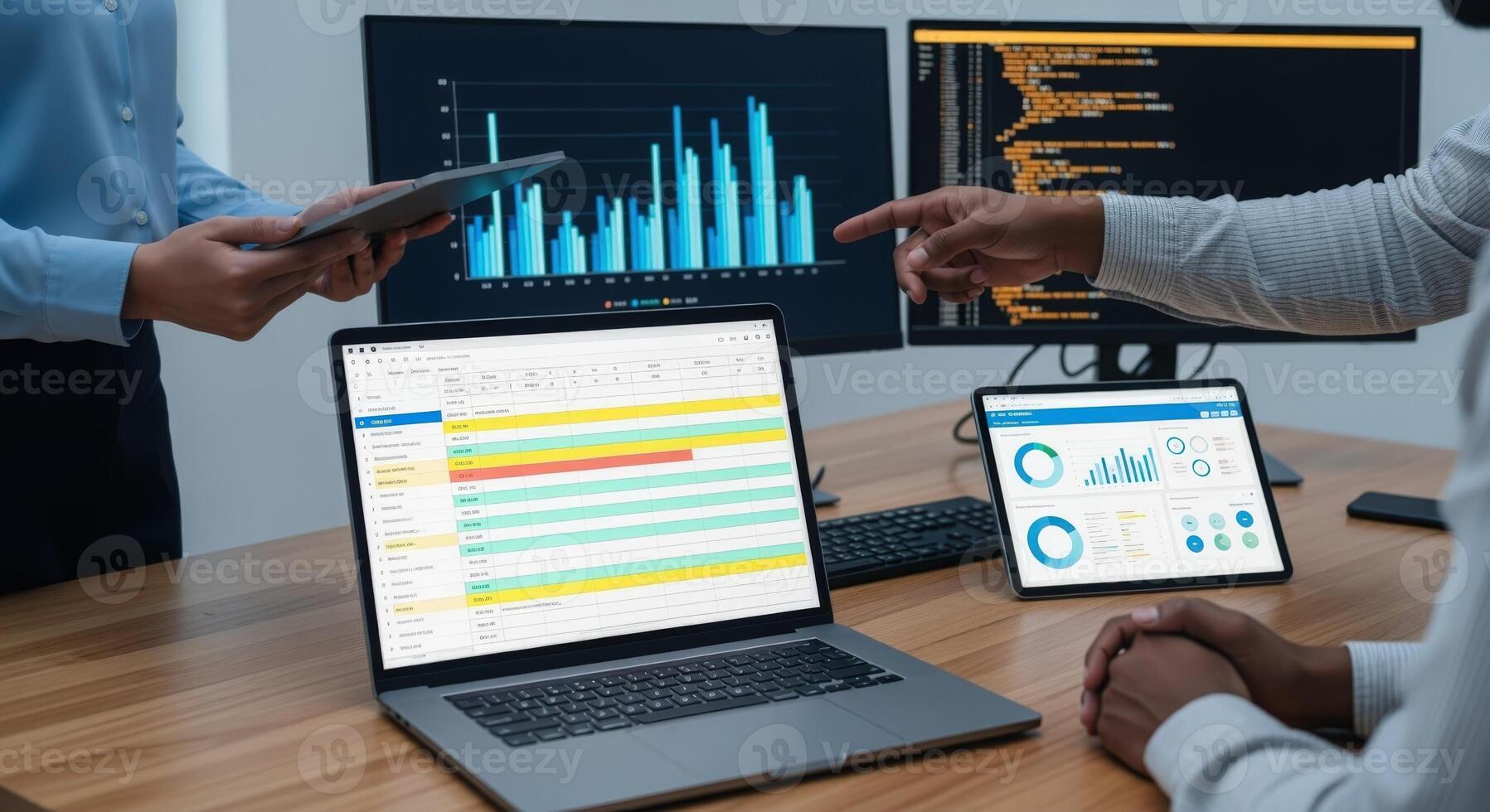 Business Professionals Analyzing Data and Charts on Multiple Digital Devices in an Office Setting photo