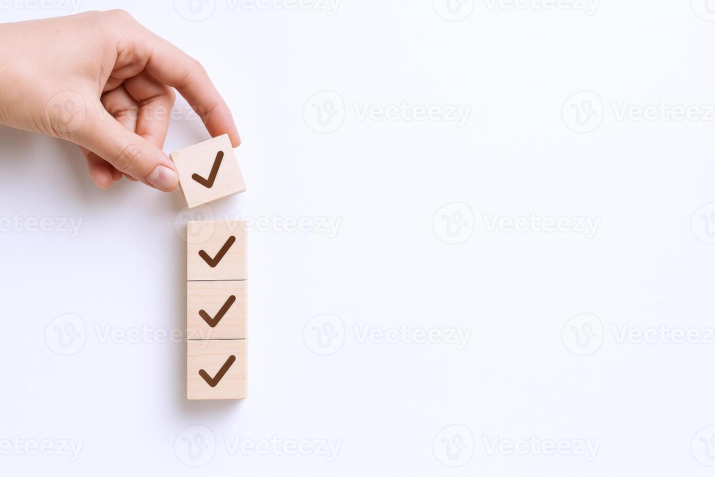 Confirmation with Check Marks Hand Placing Wooden Block on Top of Checklist Stack photo