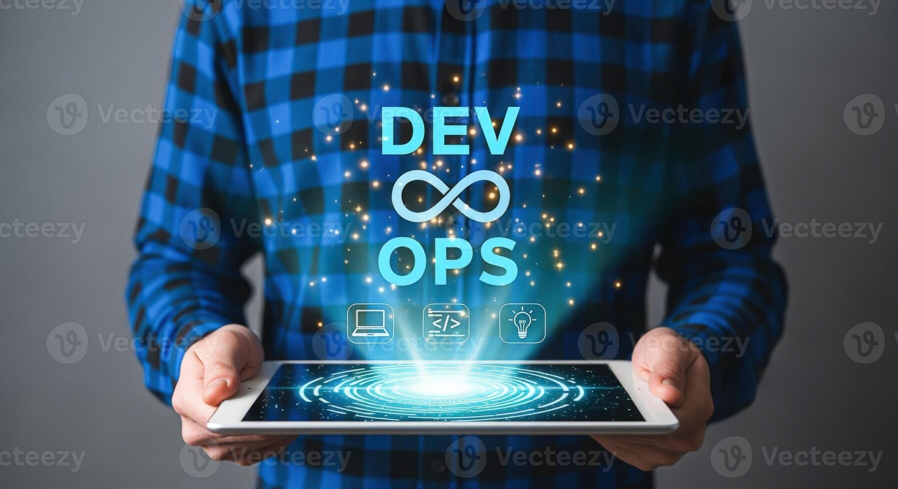 Man holds tablet displaying DevOps concept with glowing infinity symbol signifying continuous integration and delivery photo
