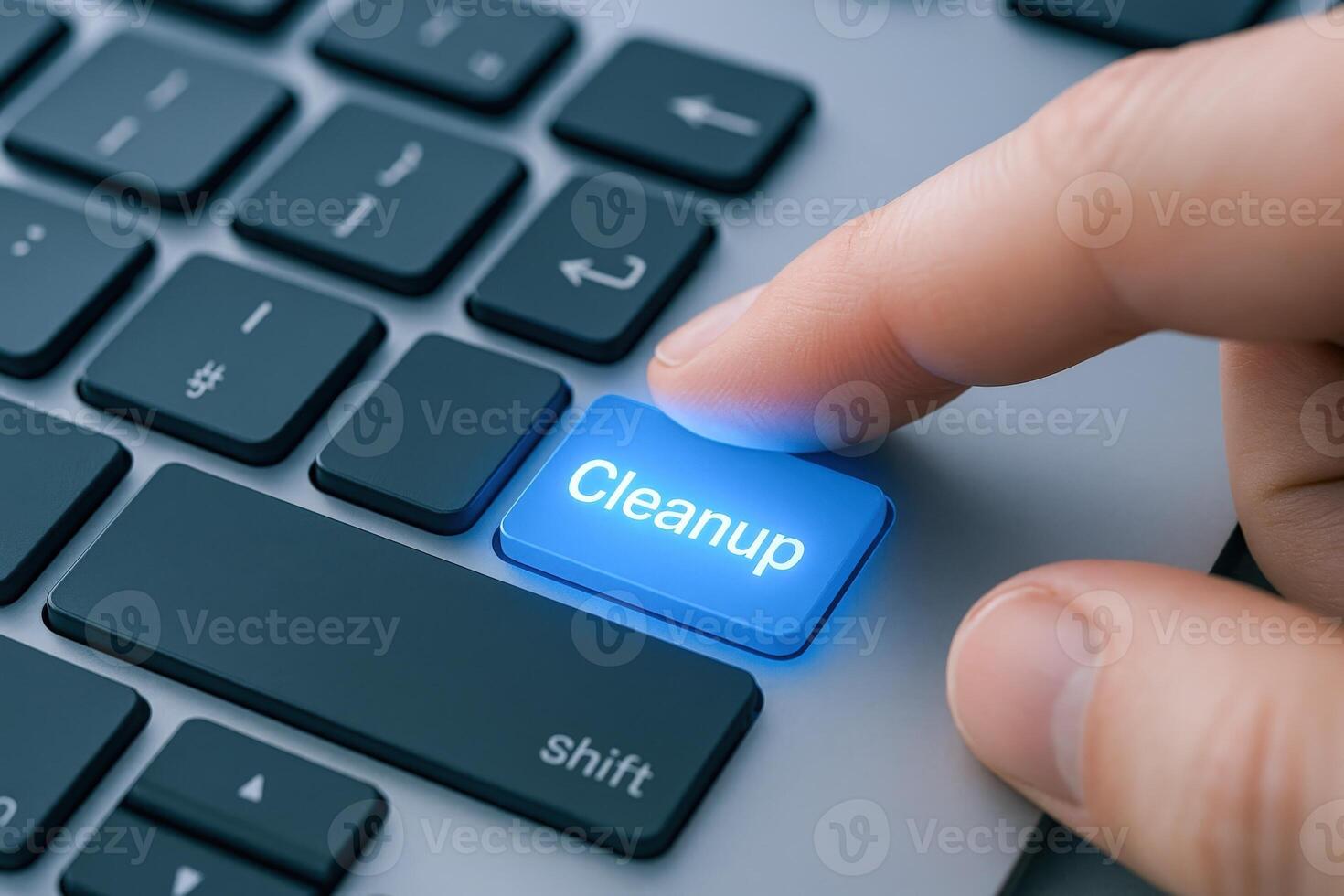 Finger Activating a Cleanup Key on a Keyboard, Illustrating Data Management and System Optimization photo