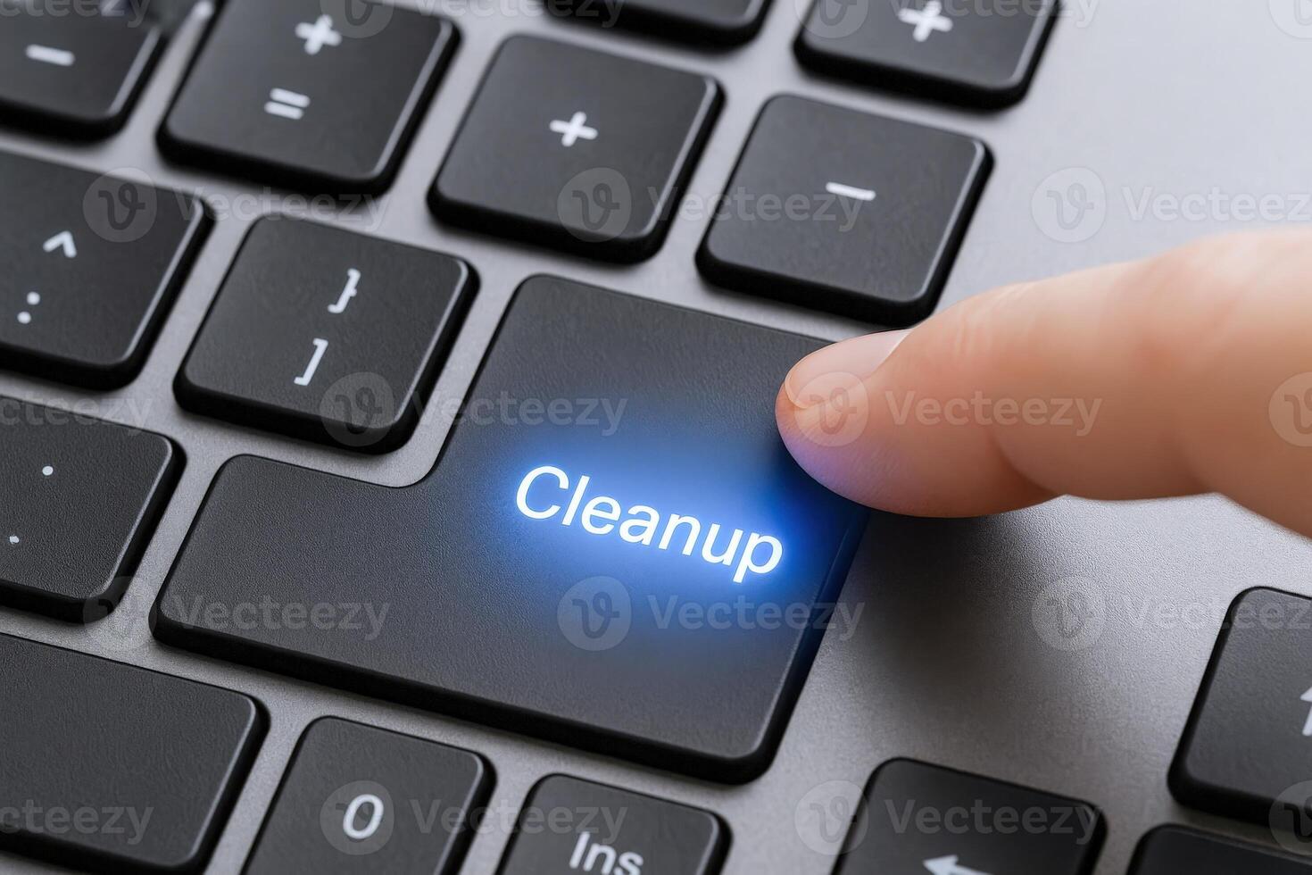 Finger Activating Cleanup Key on Keyboard Data Security, IT Hygiene, and System Maintenance Concept photo