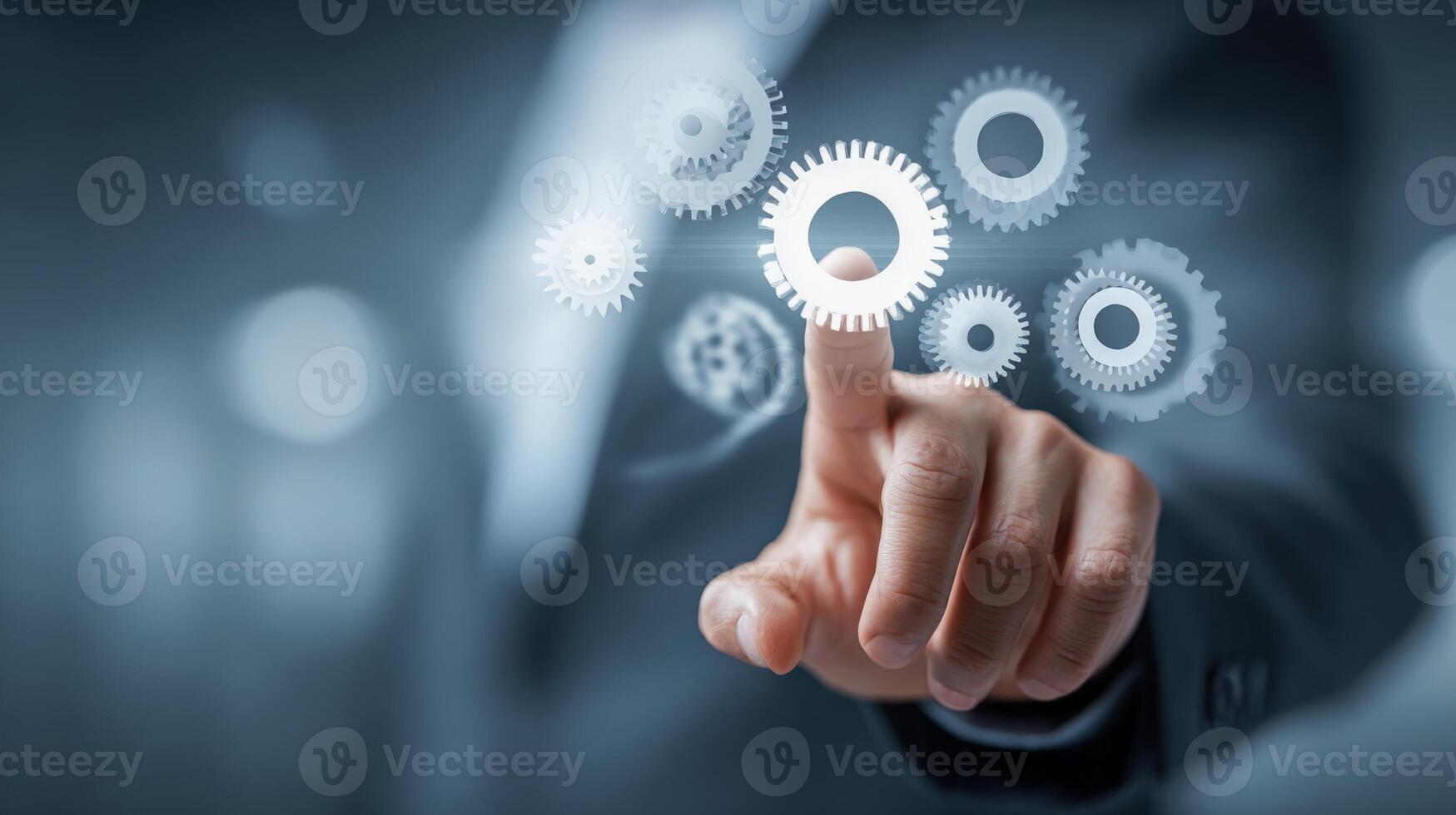 Hand Touching Digital Gears Representing Collaboration, Innovation, Technology, and Business Solutions in a Modern, Futuristic Setting photo