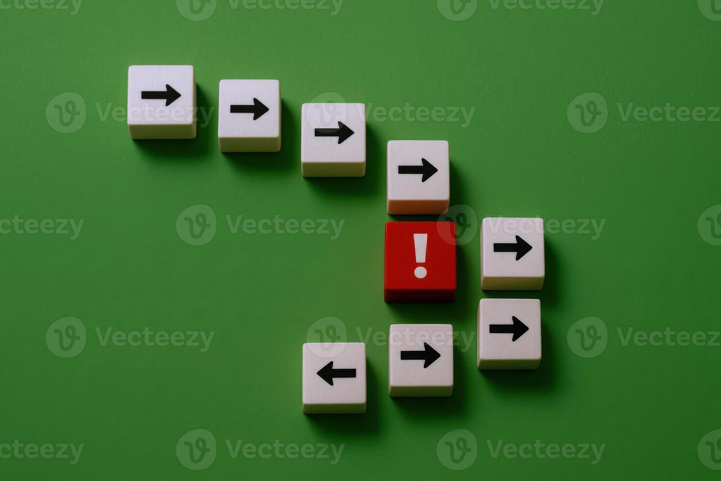 Disruption Concept Red Block with Exclamation Mark Disrupting Arrow Flow on Green Background photo