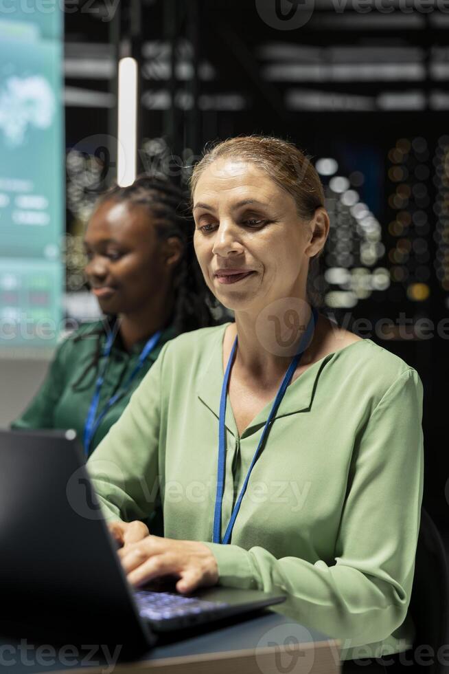 Woman consultant monitoring financial updates and targets on laptop, using data forecasting and economic analysis for goal setting and enterprise objectives. Project overview at night. photo