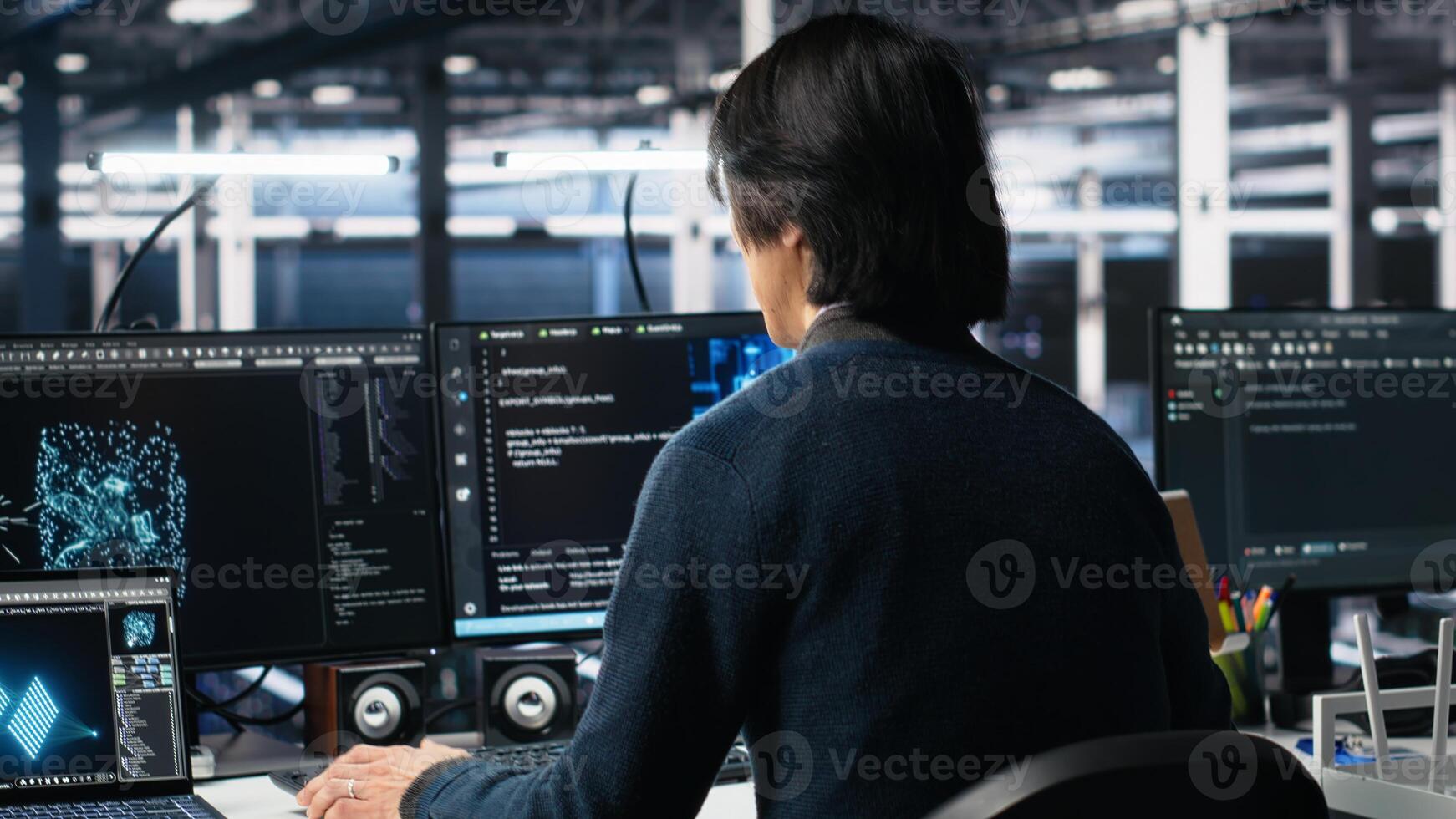 Software developer entering server room office, using AI to review infrastructure diagnostics. System administrator in data center analyzes performance data using artificial intelligence tech photo