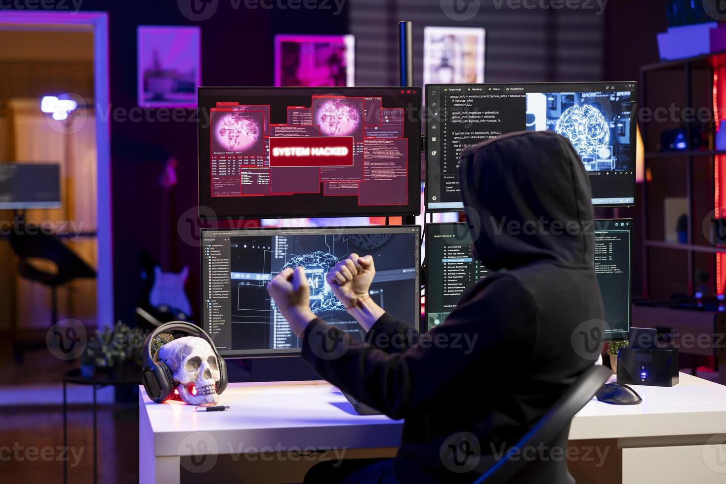 Happy hacker doing covert operations celebrating after managing to bypass advanced security. Rogue programmer delighter after successfully engineering data theft script to penetrate firewalls photo