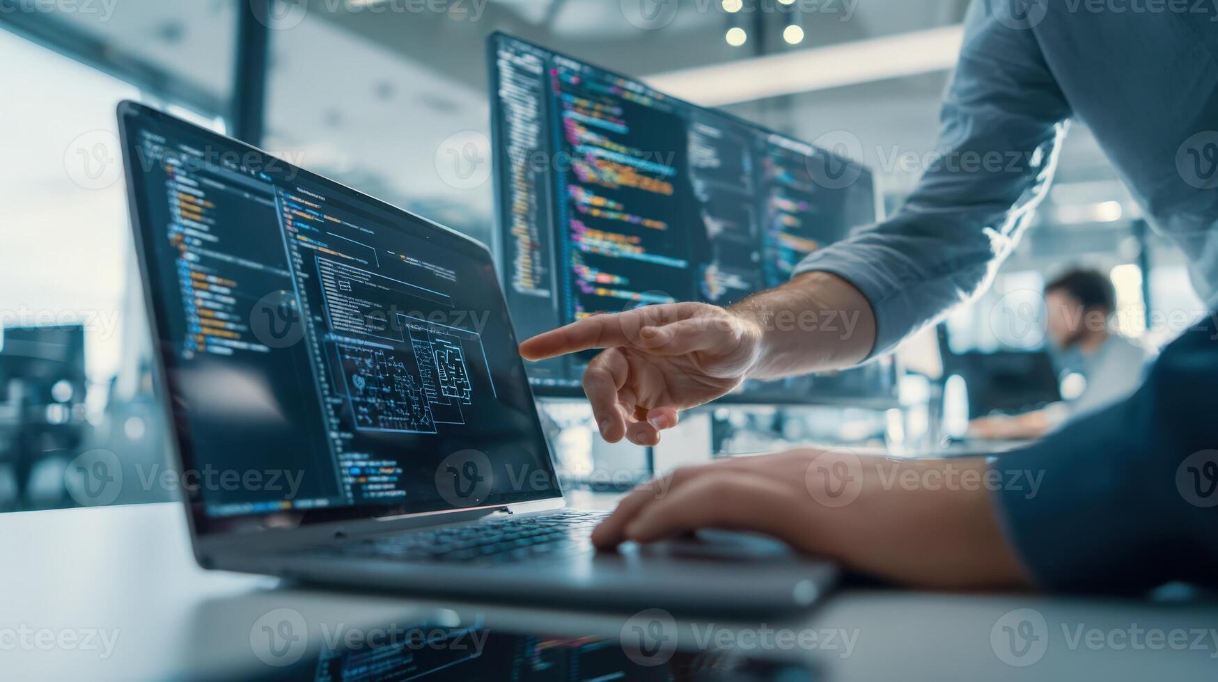 Software Developer Working with Code on Laptop and Desktop Monitors in Modern Office Environment photo