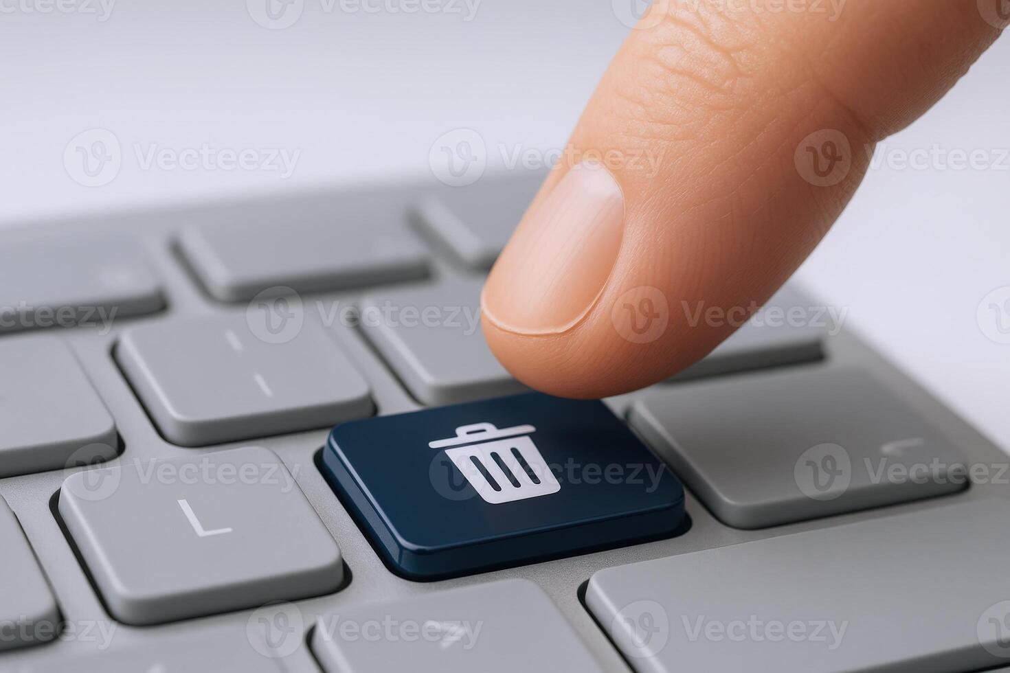 Finger pressing delete key, data removal concept on computer keyboard for cleaning files and recycle photo